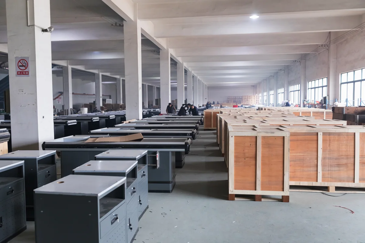 Rows of finished checkout counters and packed export crates on the Keshun factory floor in Changshu
