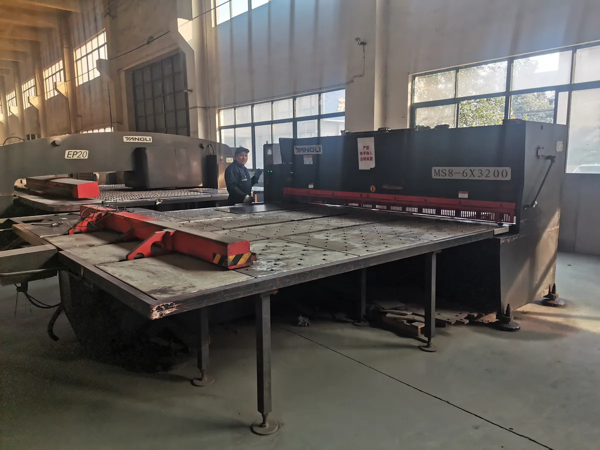CNC turret punch press and hydraulic shearing machine preparing steel sheet in the Keshun steel workshop