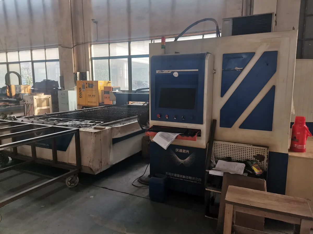 Laser cutting machine cutting nested sheet metal blanks for supermarket fixtures at Keshun