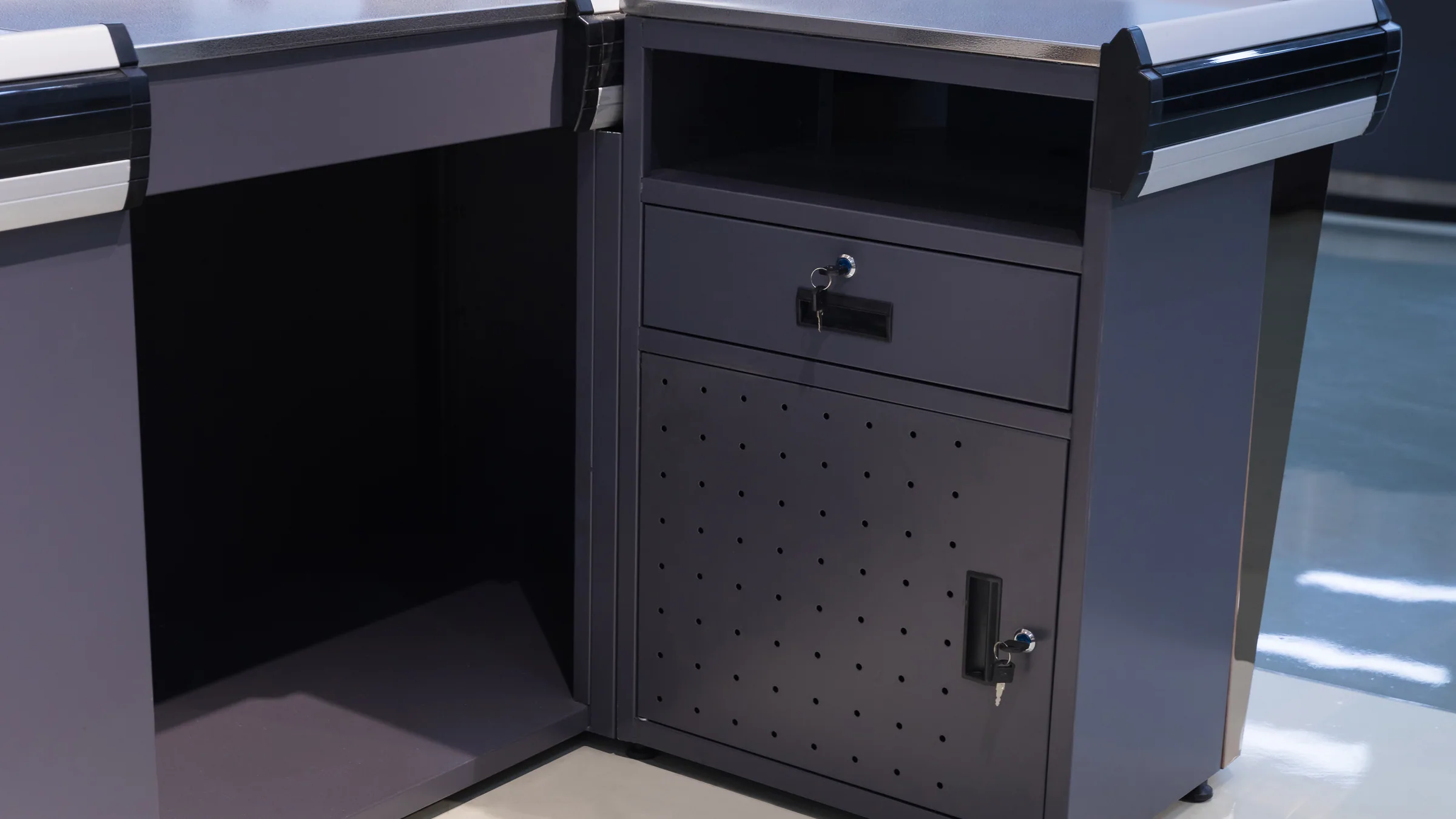 Compact checkout counters and front-end fixtures arranged in the Keshun showroom