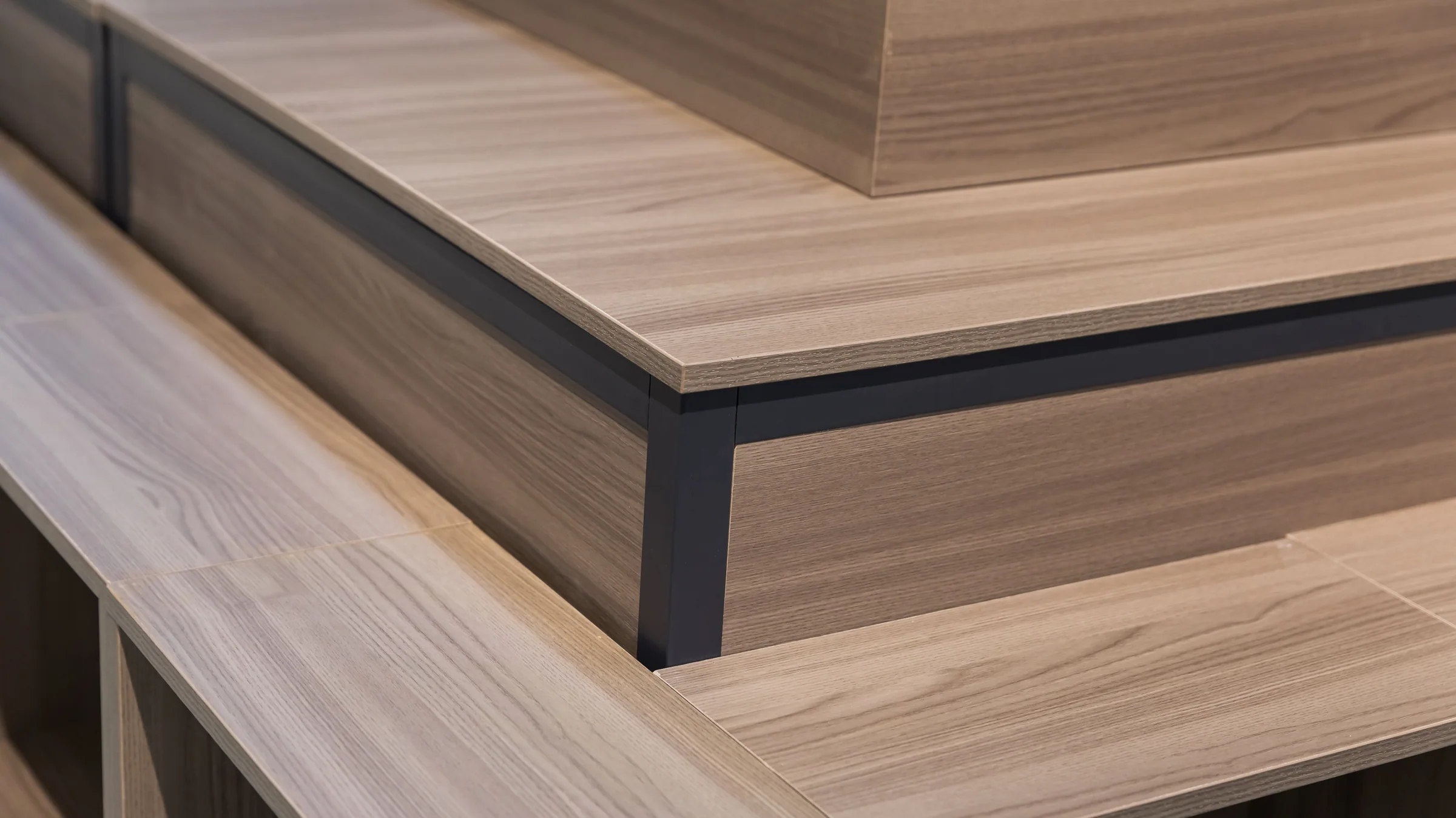 Tiered timber promotion tables arranged as a combined block in the Keshun showroom