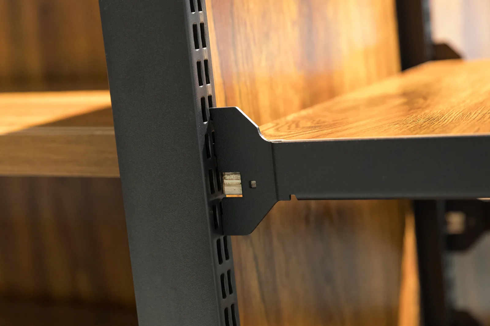 A run of steel and wood shelving bays with shelf positions set for reach