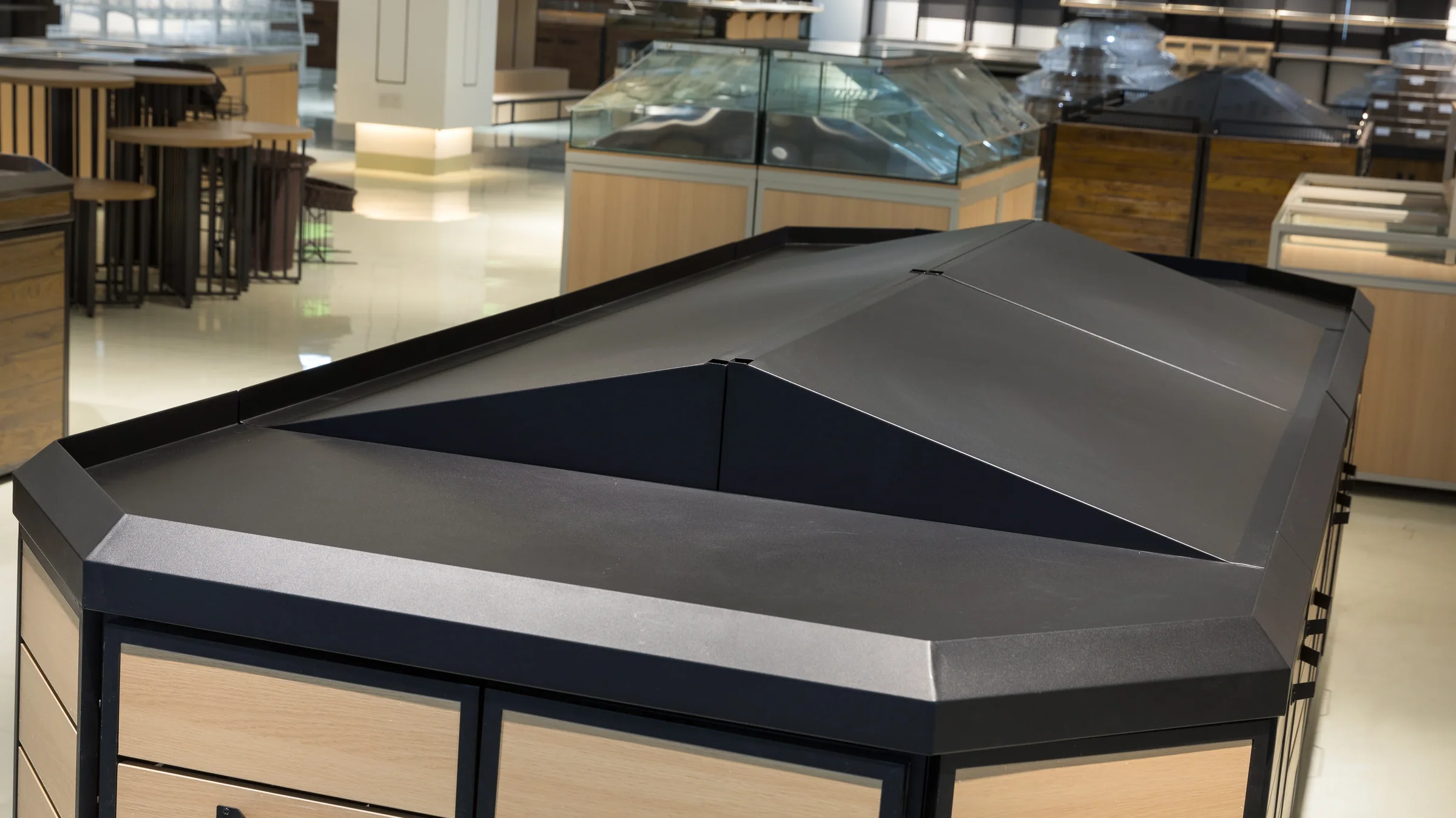 Wooden produce racks and stainless display tables in the Keshun fresh food showroom