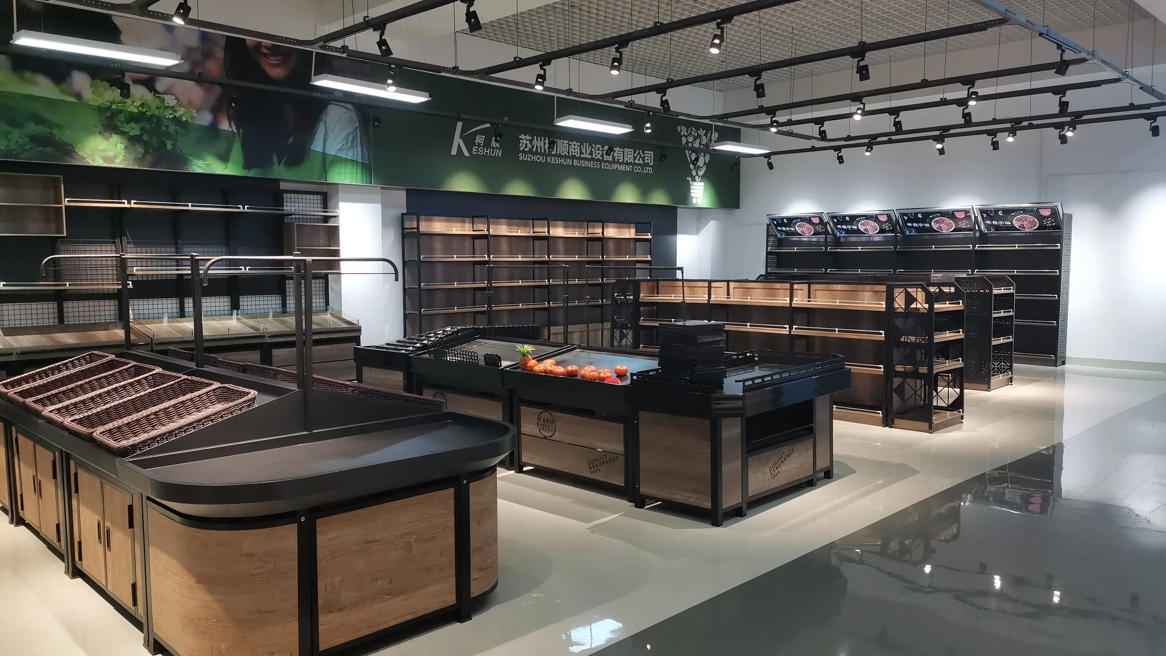 Fresh produce zone in the Keshun showroom with double-sided island racks and wall runs in wood and steel