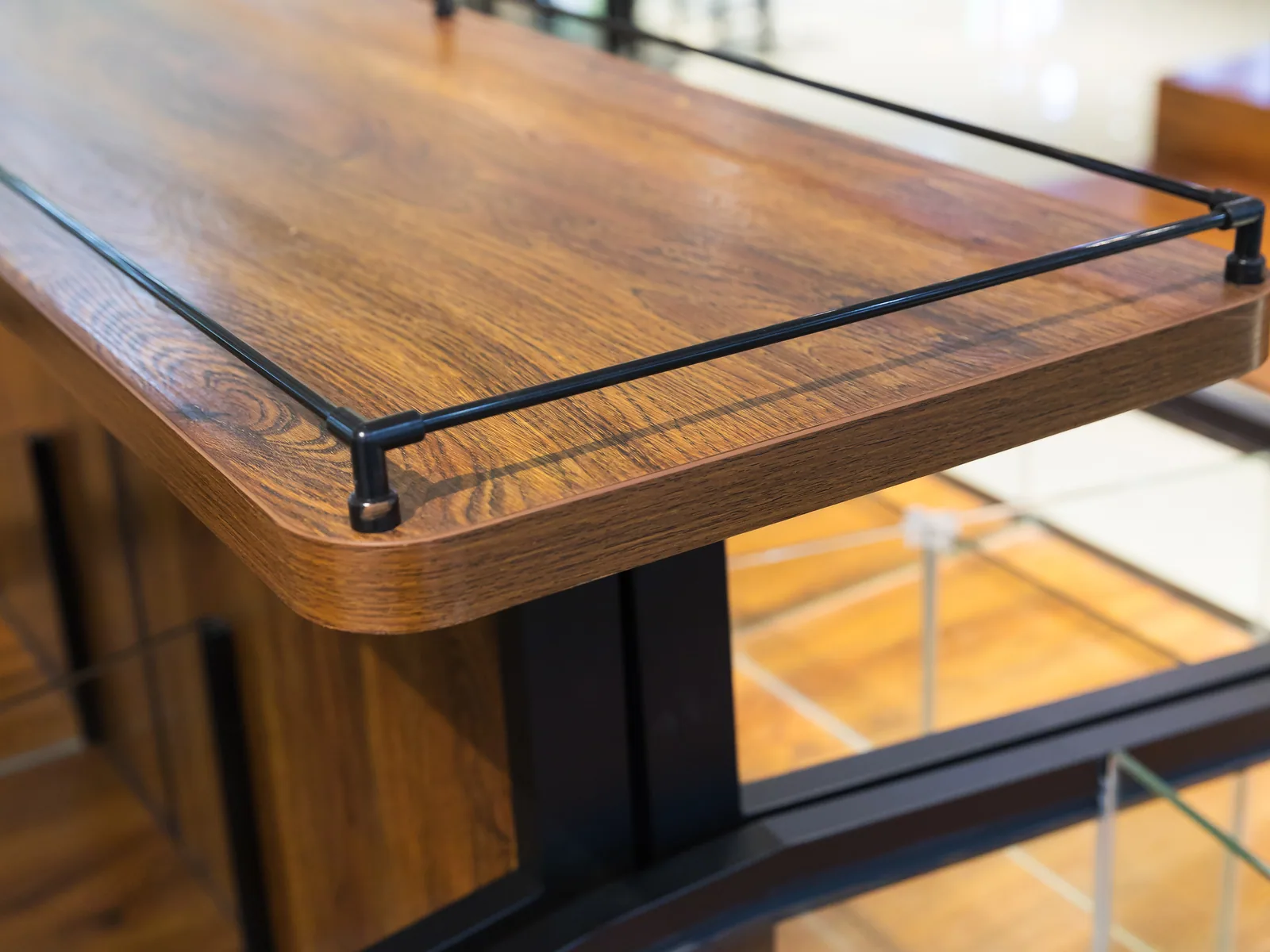 Close-up of a timber bulk food island body and bin rail in the Keshun showroom