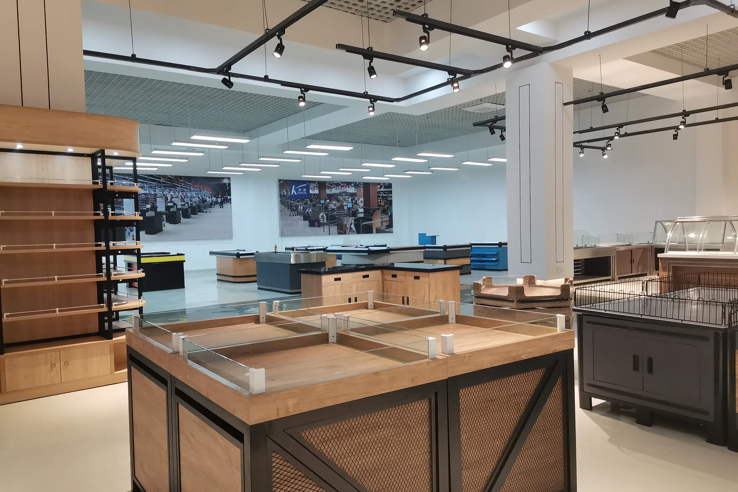 Timber display tables and grain rack bodies under track lighting in the Keshun showroom