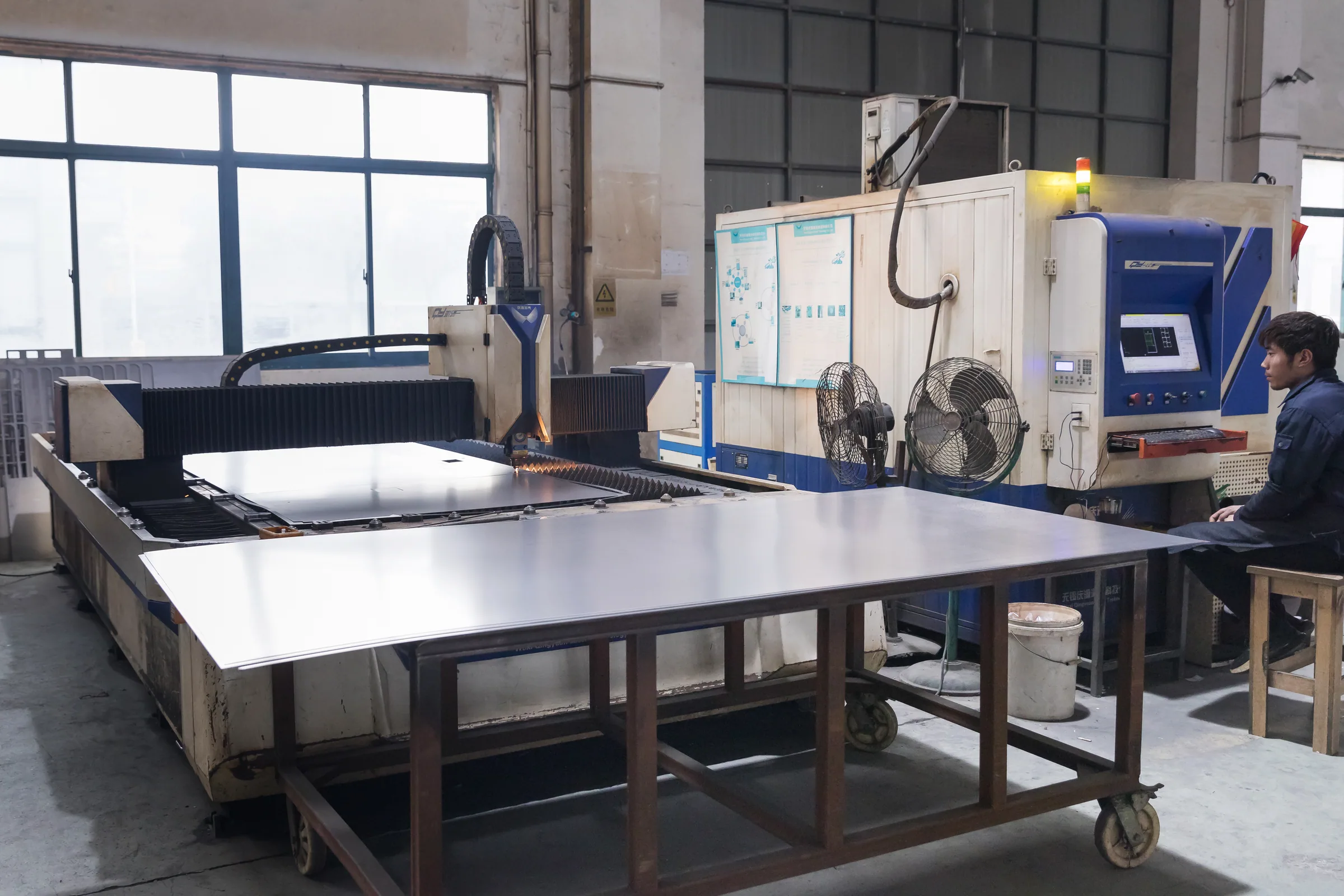 Stainless steel sheet on the cutting bed in the Keshun plant, the stock an ice fresh table is folded from