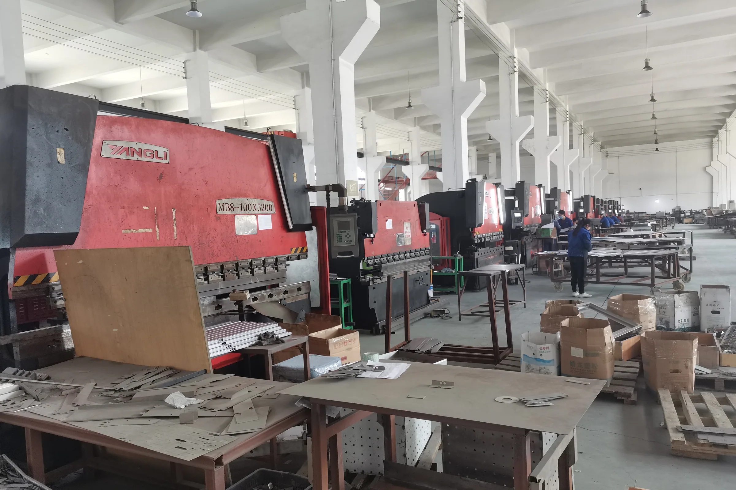 Frame assembly benches in the Keshun plant where shopping trolley frames are built
