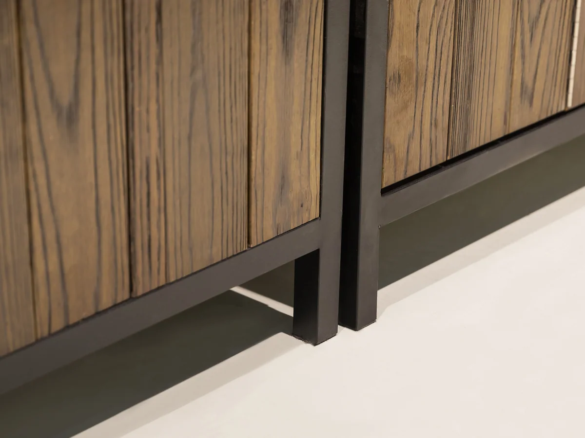 Close-up of the black steel plinth and frame leg carrying the island clear of the floor