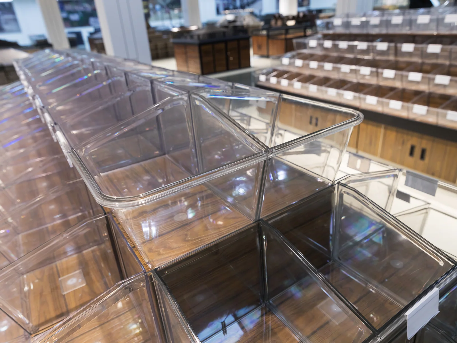 Tiered tilt bin island photographed from the end, showing the rounded corner and the closed cabinet base