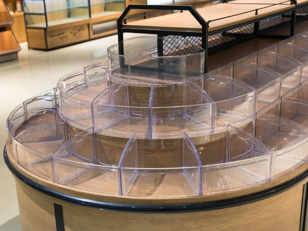 Close-up of the stepped clear tilt bins arranged over the curved head of the island