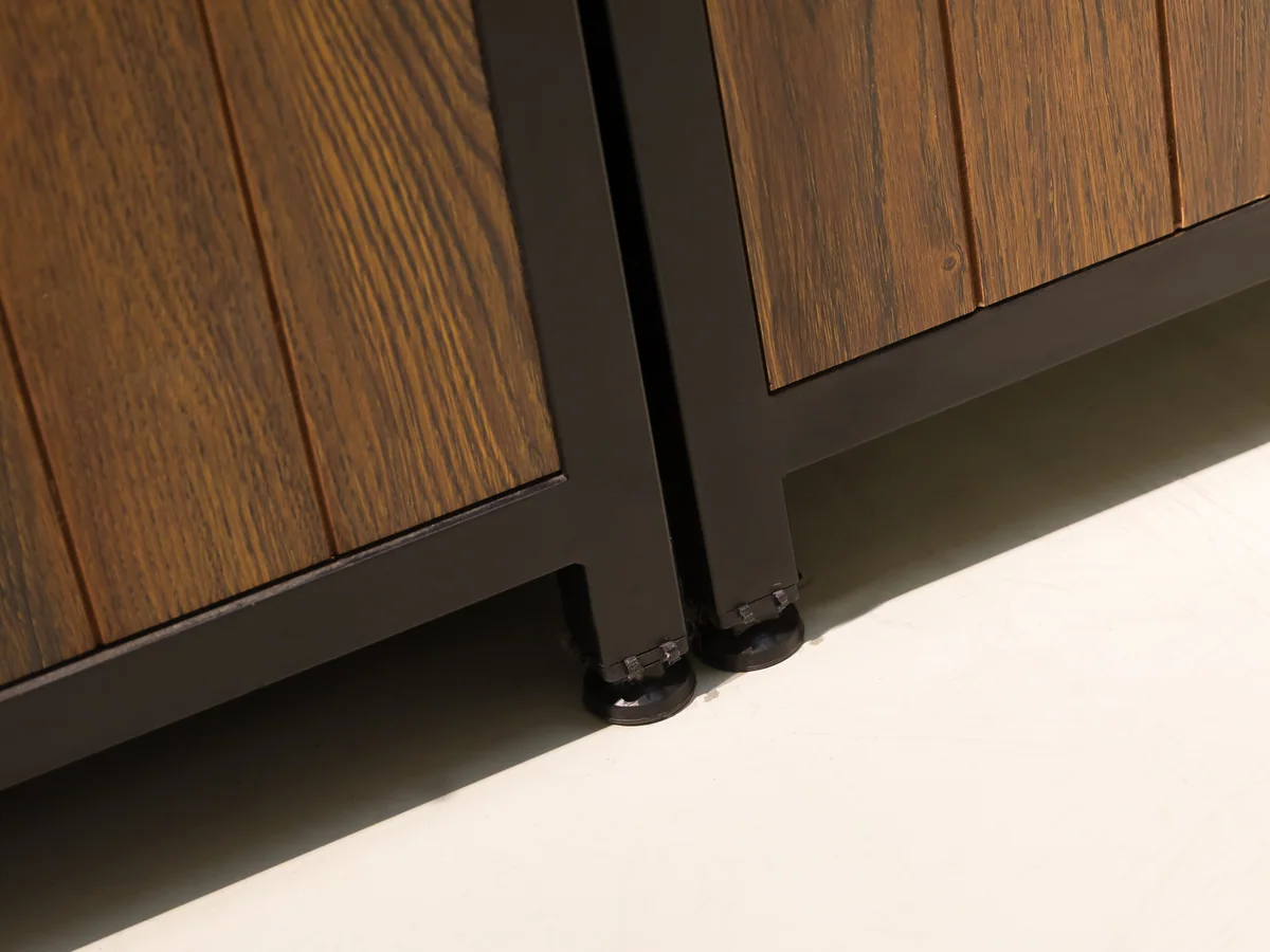 Close-up of the welded black steel frame corner where the uprights meet the top rail