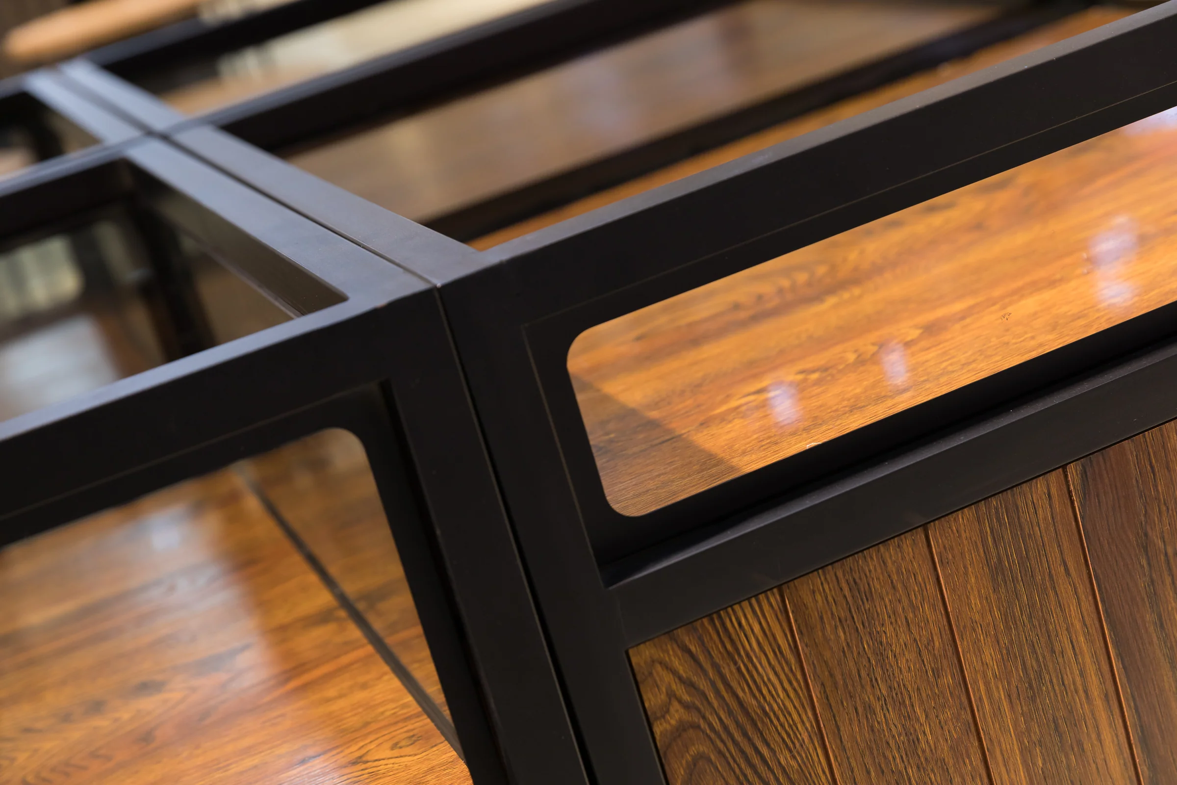 Keshun cross braced square dry goods cabinet with a glazed top and dark timber doors on four faces
