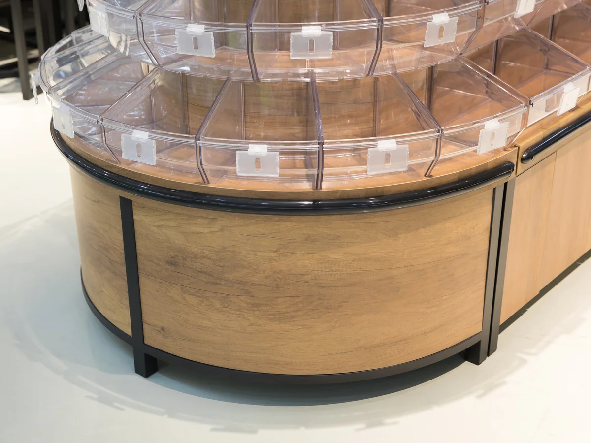 Close-up of the curved head of the island with the tilt bin tiers following the curve