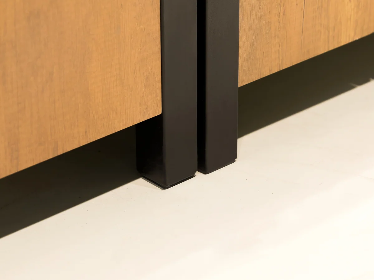 Close-up of the square black steel leg supporting the island deck
