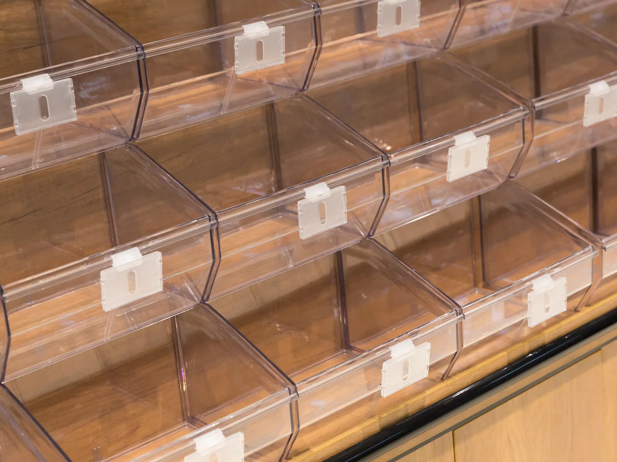 Straight-on close-up of the clear tilt bins in rows showing the depth of the stepped arrangement