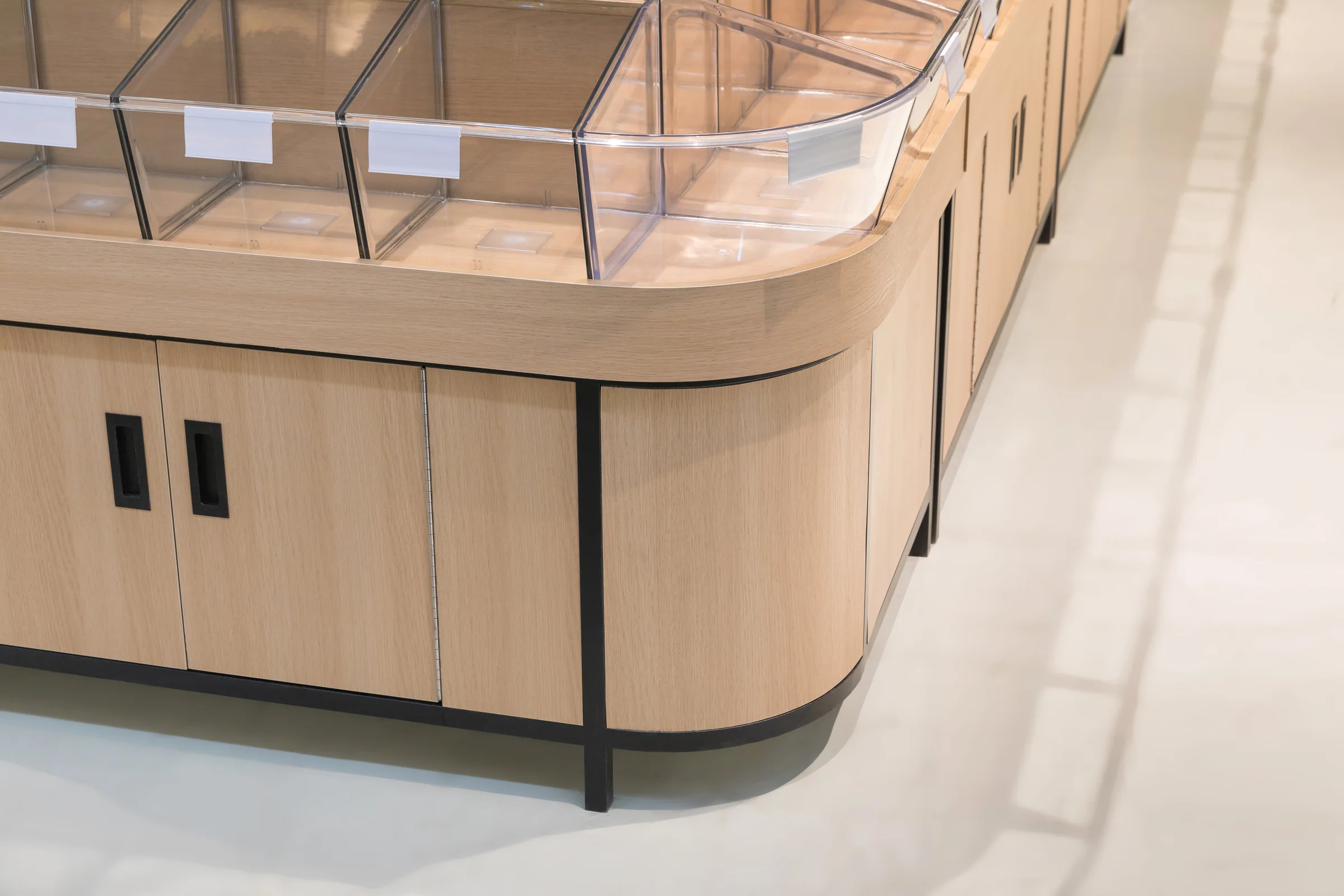 Keshun high capacity tilt bin island in pale timber with four rows of clear bins