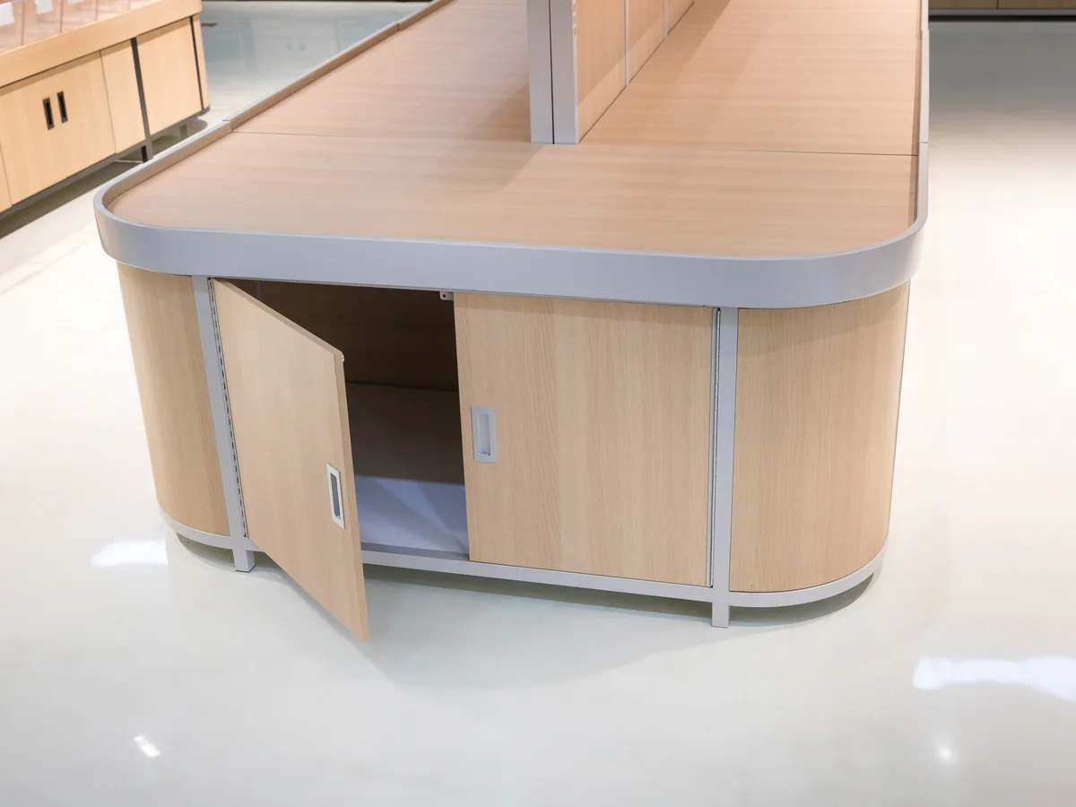 Close-up of an open cabinet door on the light timber base showing the interior