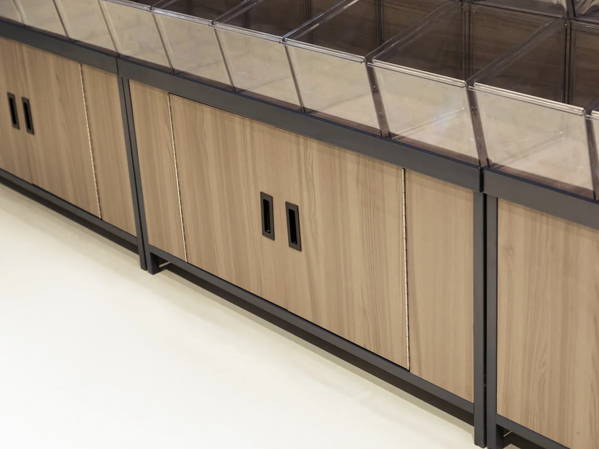 Close-up of the timber cabinet doors framed by the black steel structure