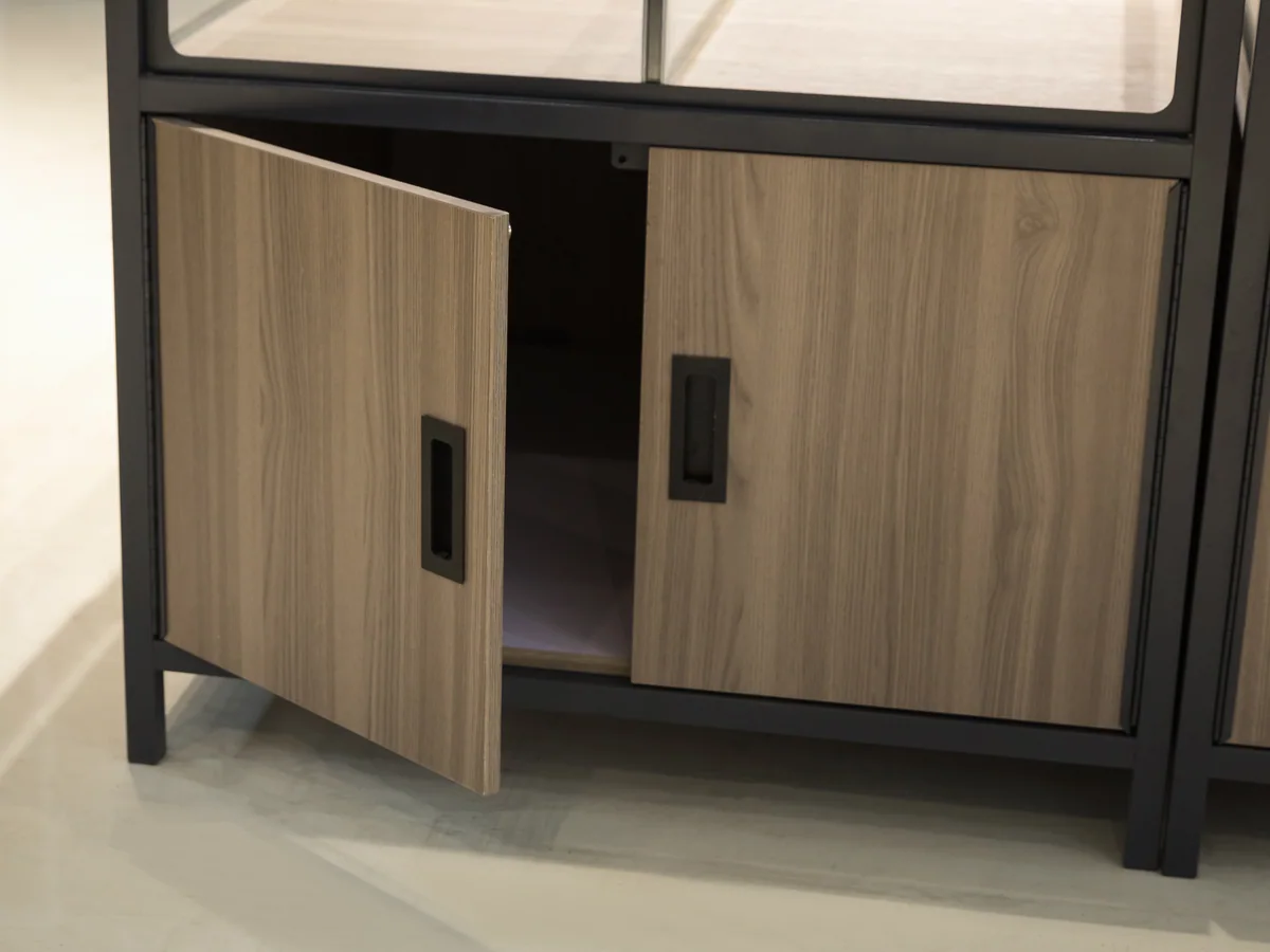 Close-up of an open cabinet door in the light timber base