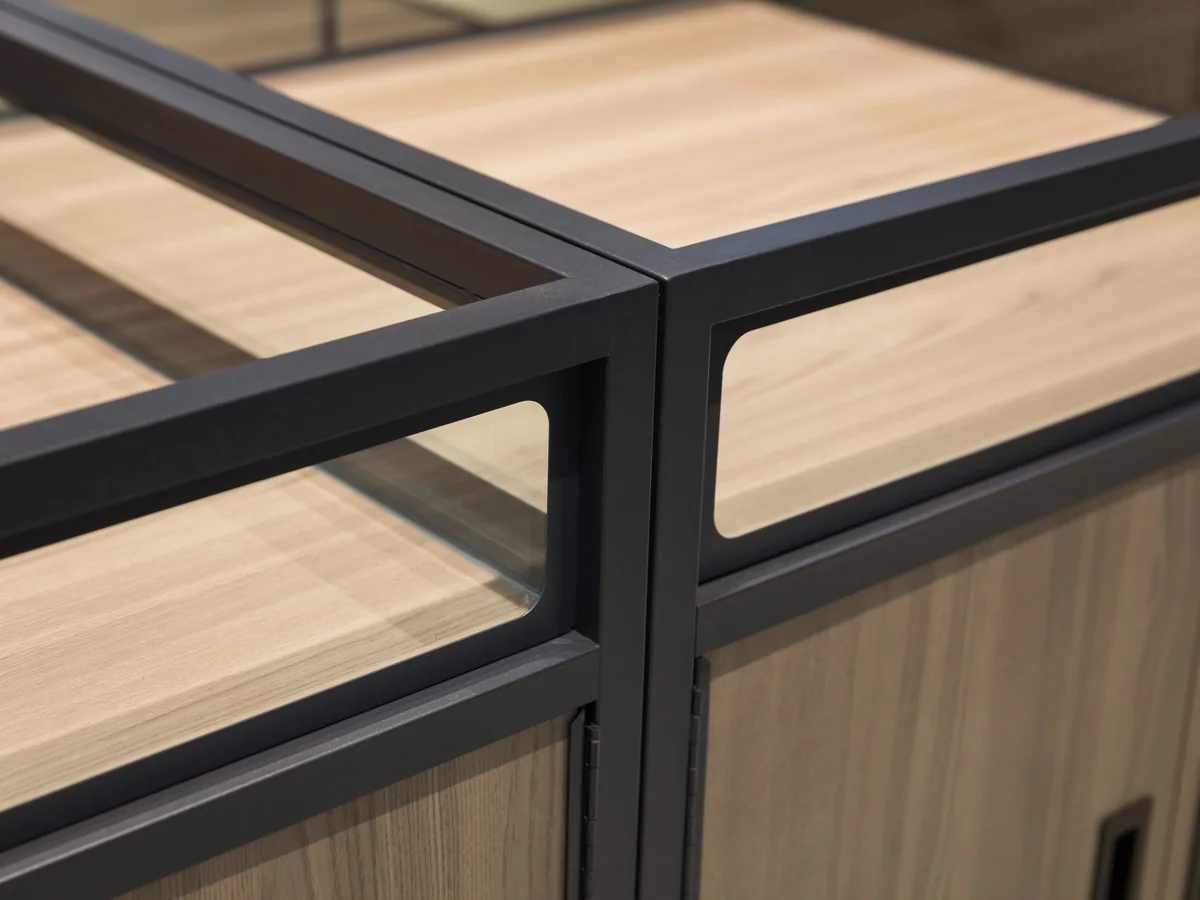 Close-up of the corner of the cabinet showing the frame, glass and timber together