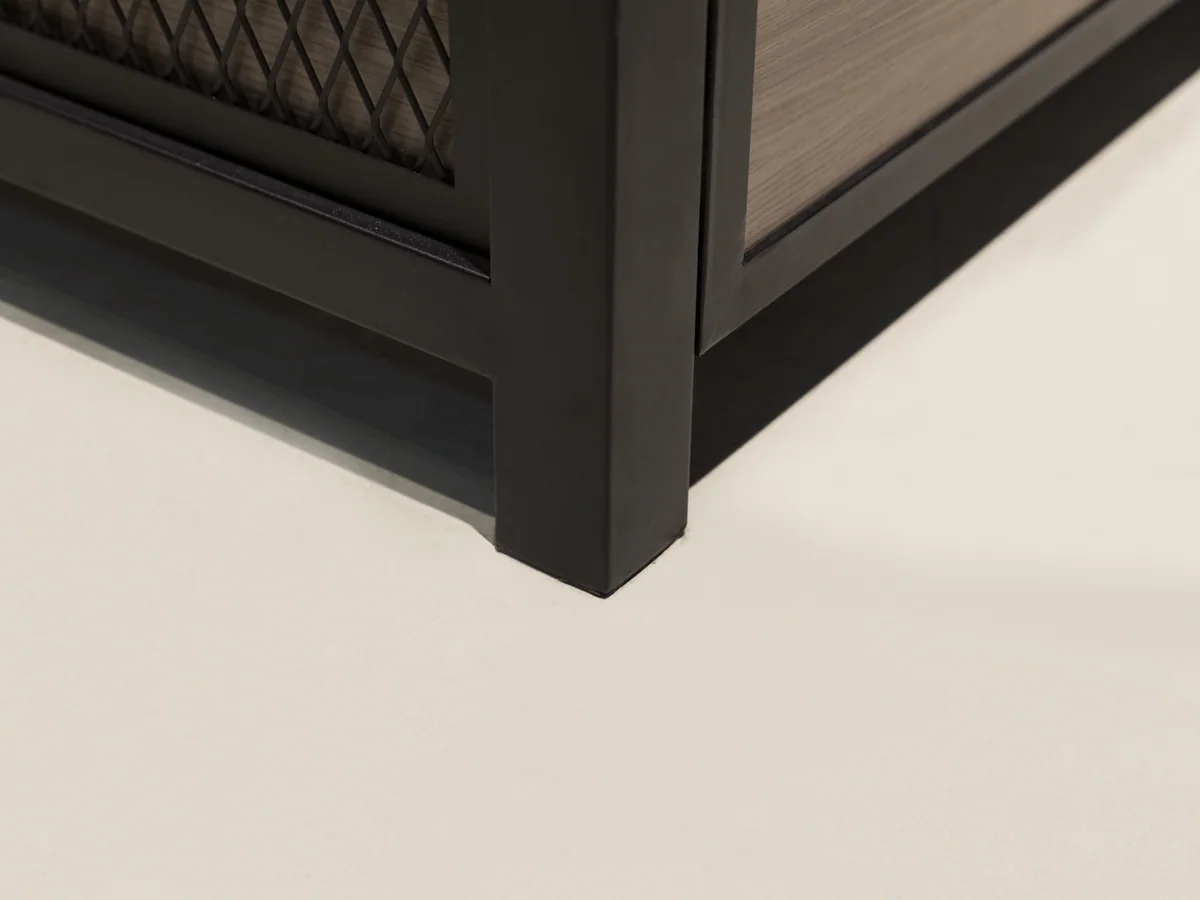 Close-up of the black plinth foot at the corner of the island