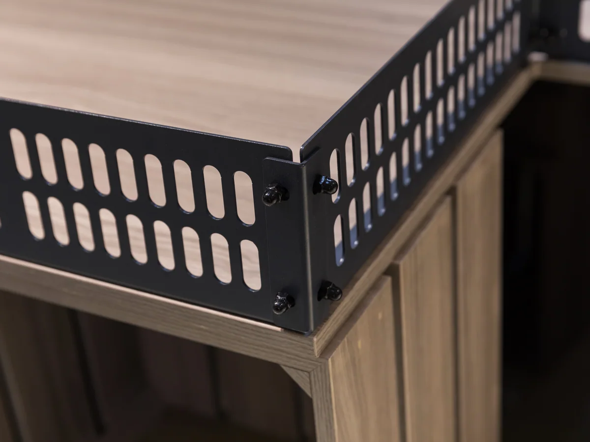 Close-up of the black perforated panel that forms the signage header