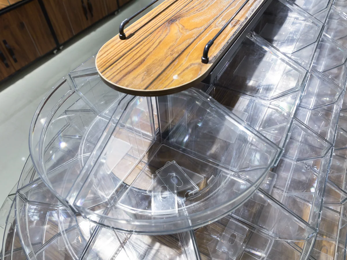 Close-up of the round timber lid capping the top of the bin tower