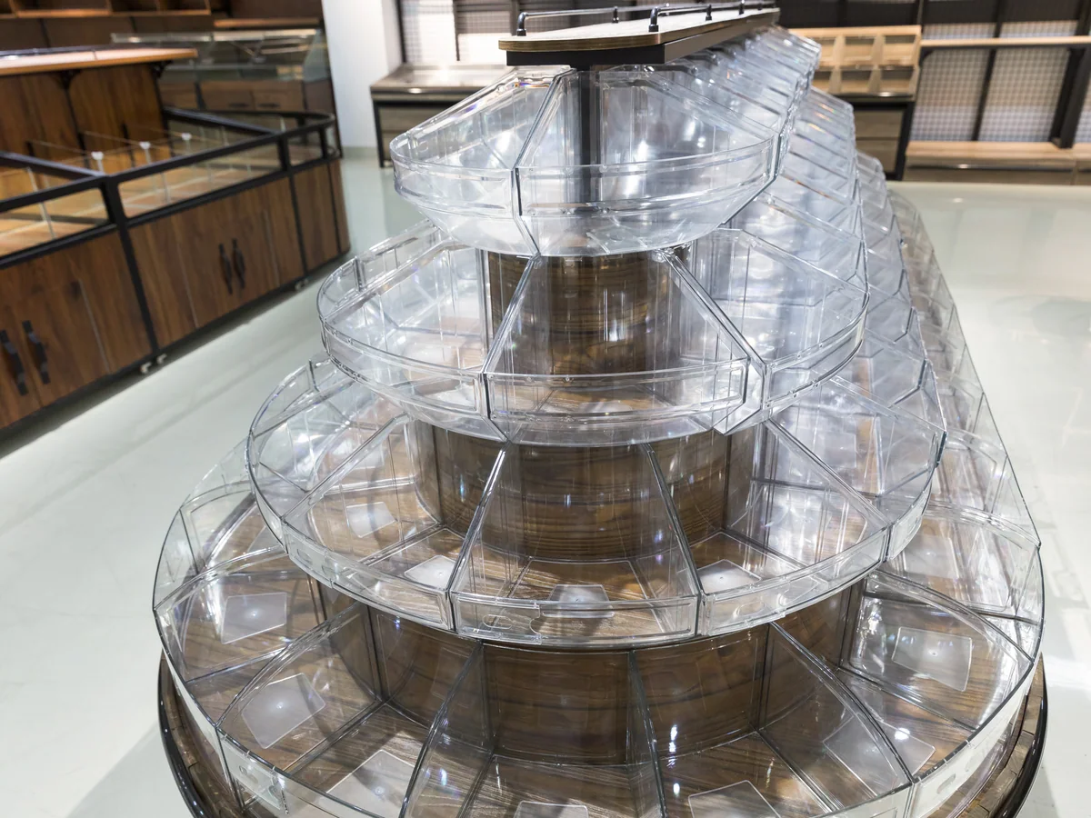The bin tower photographed from an angle showing the rings climbing the staved body