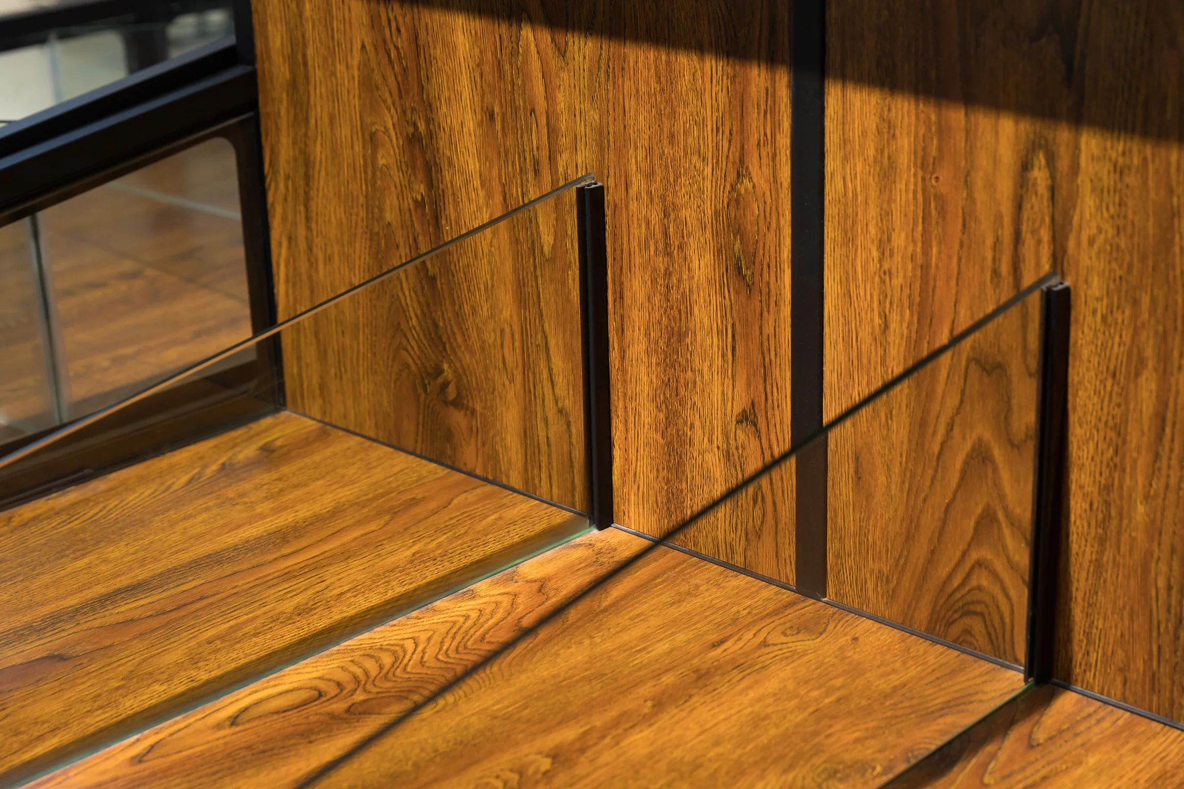 Keshun glazed top bulk island with ticket rails, dark timber doors and adjustable levelling feet