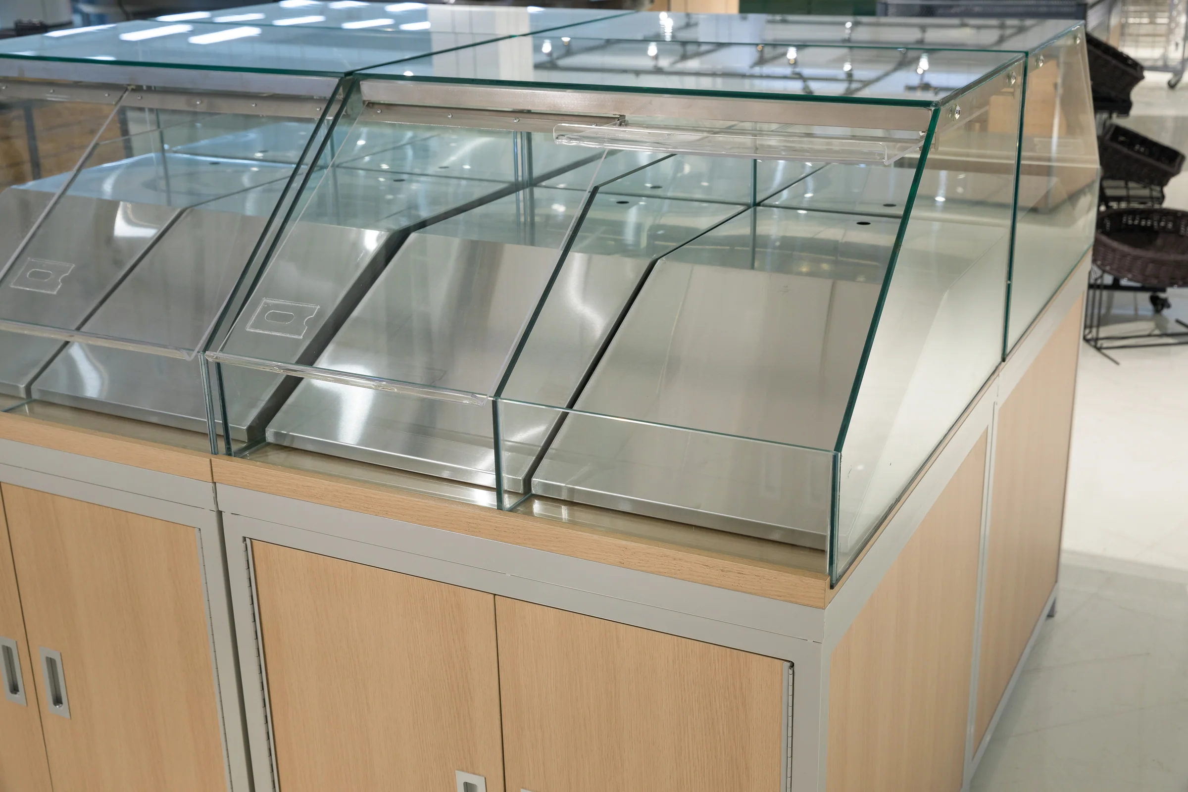 Keshun twin bay bakery display case with curved glass fronts and a pale timber base