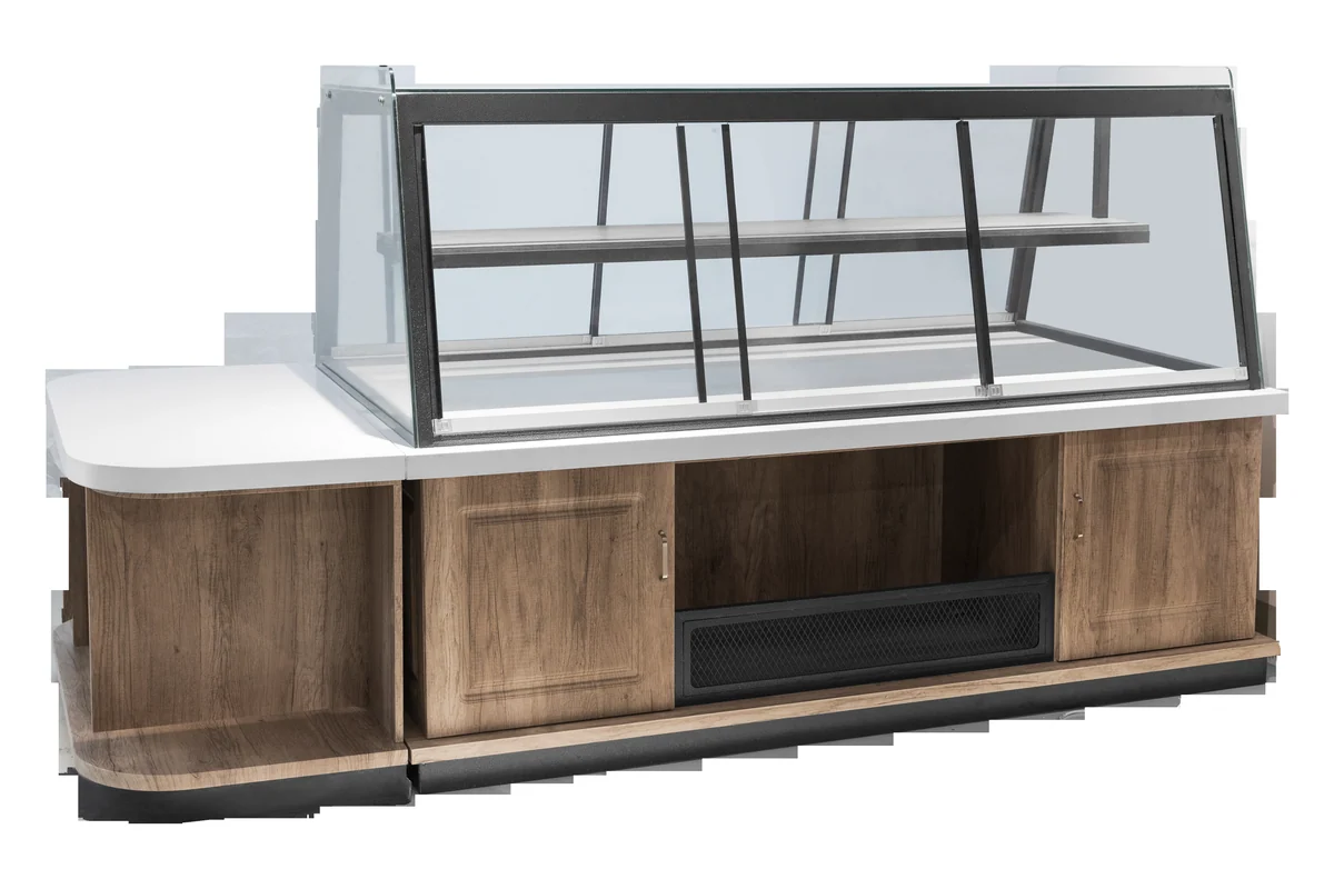 Long bakery counter with an angled glass front over a timber carcase and a pale stone worktop