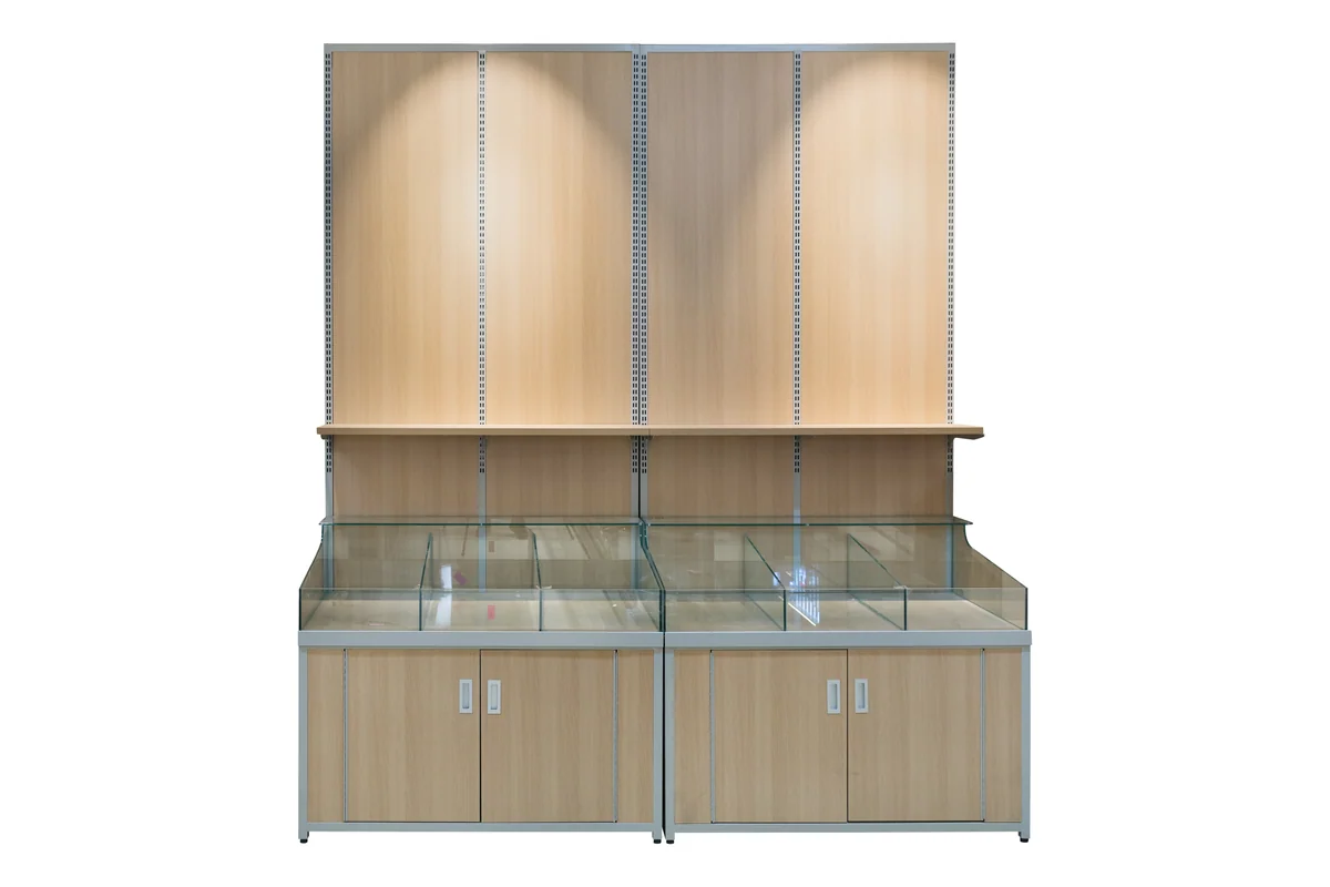 Supermarket dry goods wall cabinet with an illuminated back panel behind glazed bins