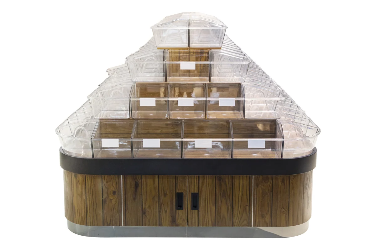 Pyramid-shaped supermarket bulk food display with stepped rows of clear bins