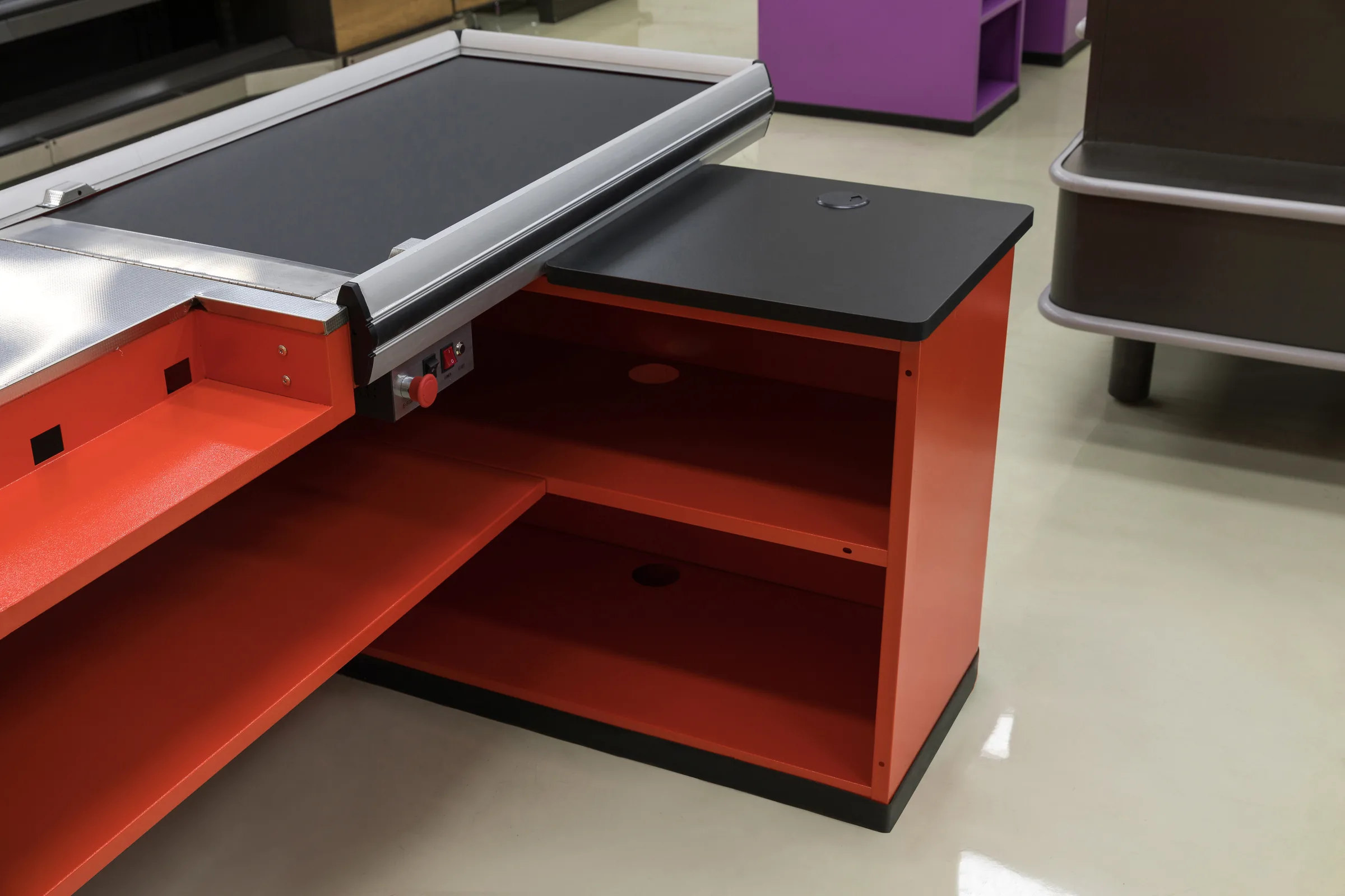 Belt end, control panel and open packing bay of a Keshun supermarket checkout counter in the showroom
