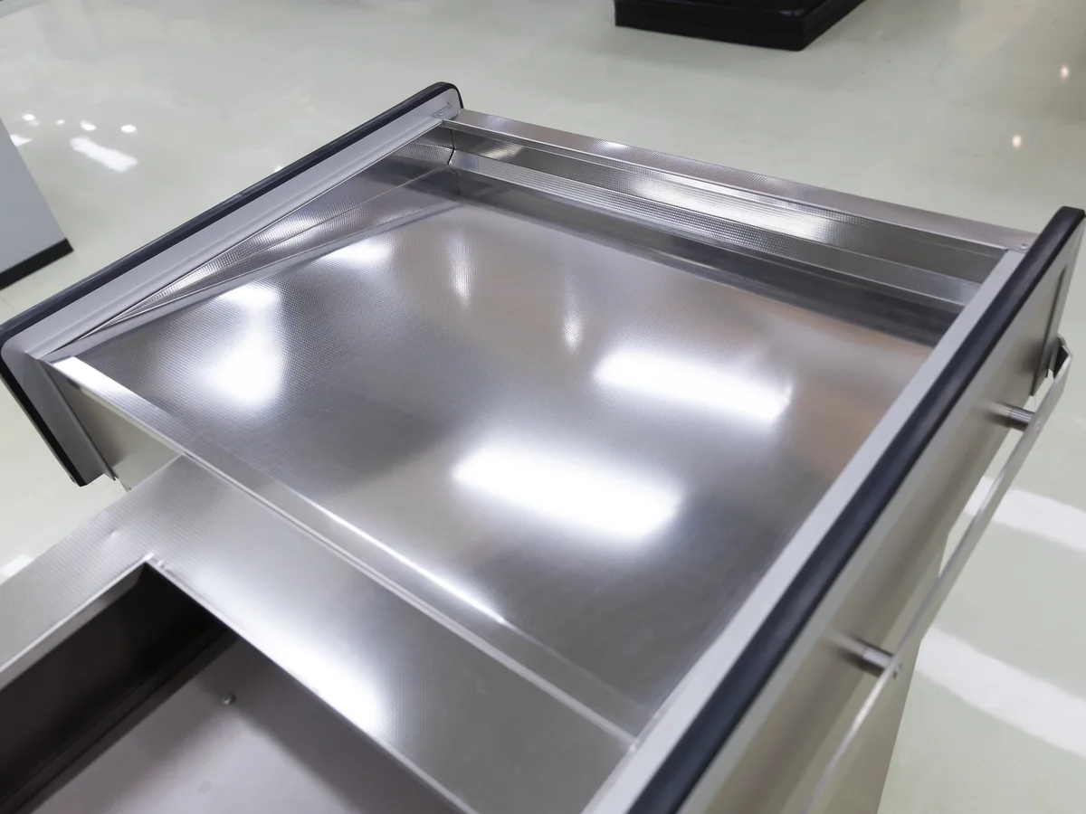 Open drawer in the bank under the worktop of a Keshun cashier counter