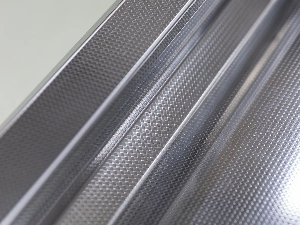 Embossed stainless deck surface on a Keshun supermarket cashier counter