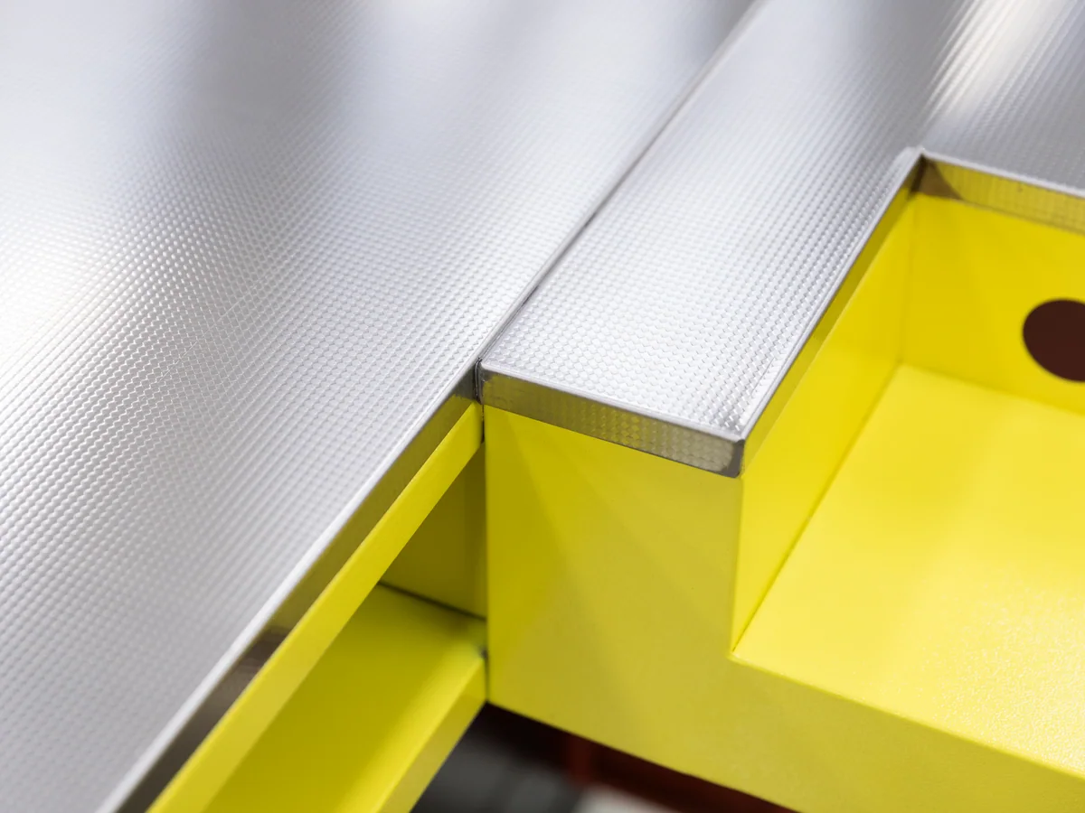 Close-up of the pressed stainless worktop against the coloured body