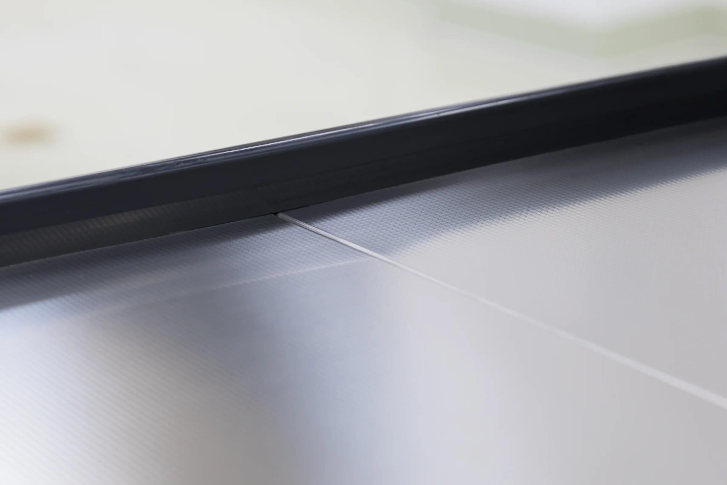 Keshun two colour retail checkout counter with a bright top rail over a contrasting front panel