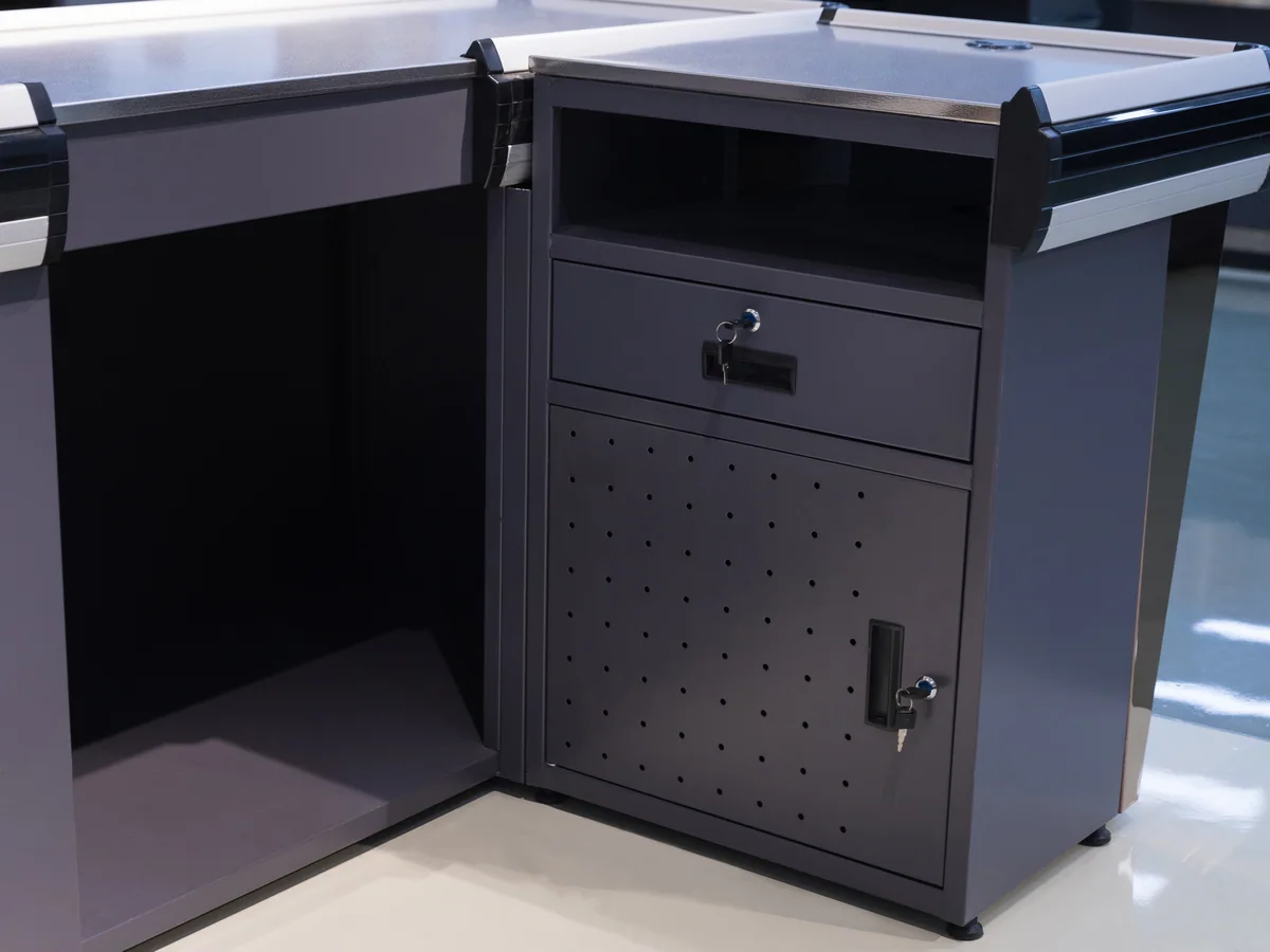 Close-up of the angled edge where a dark inset panel meets the pale timber facing