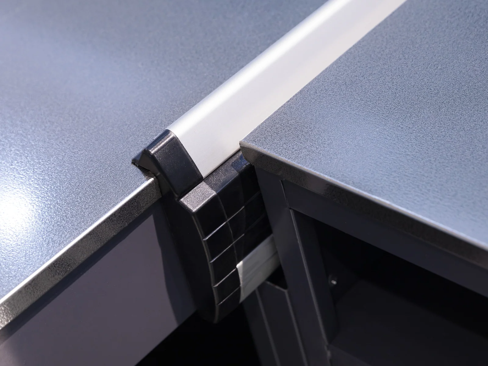 Angled wood checkout counter photographed from the corner, showing the dark inset panels