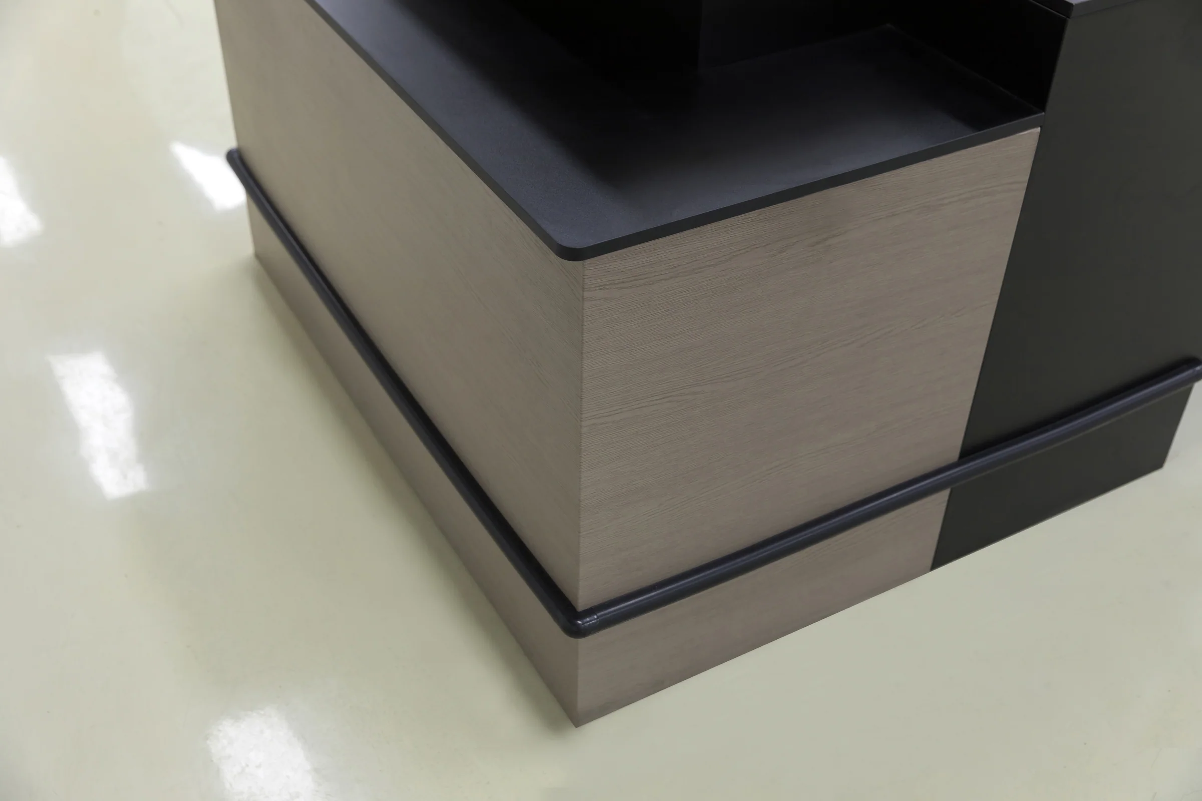 Keshun open frame cashier counter with a stainless top on an unclad steel frame
