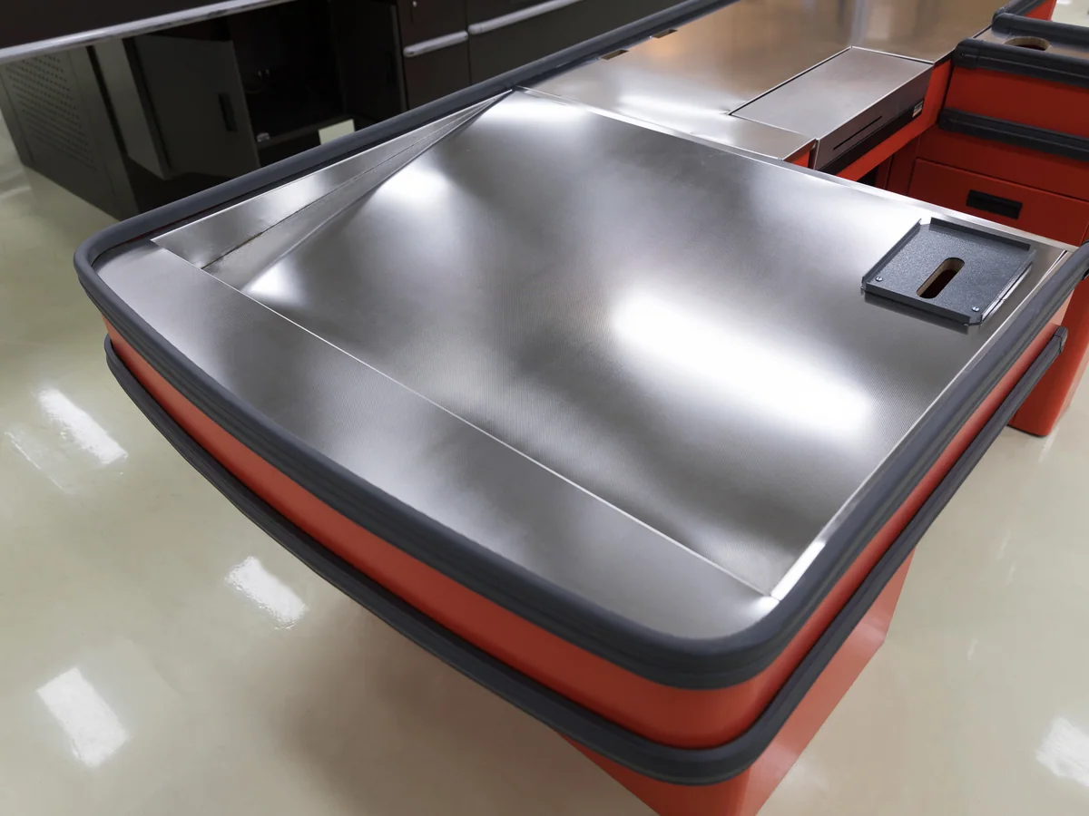 Close-up of the chrome stool at the seated cashier position