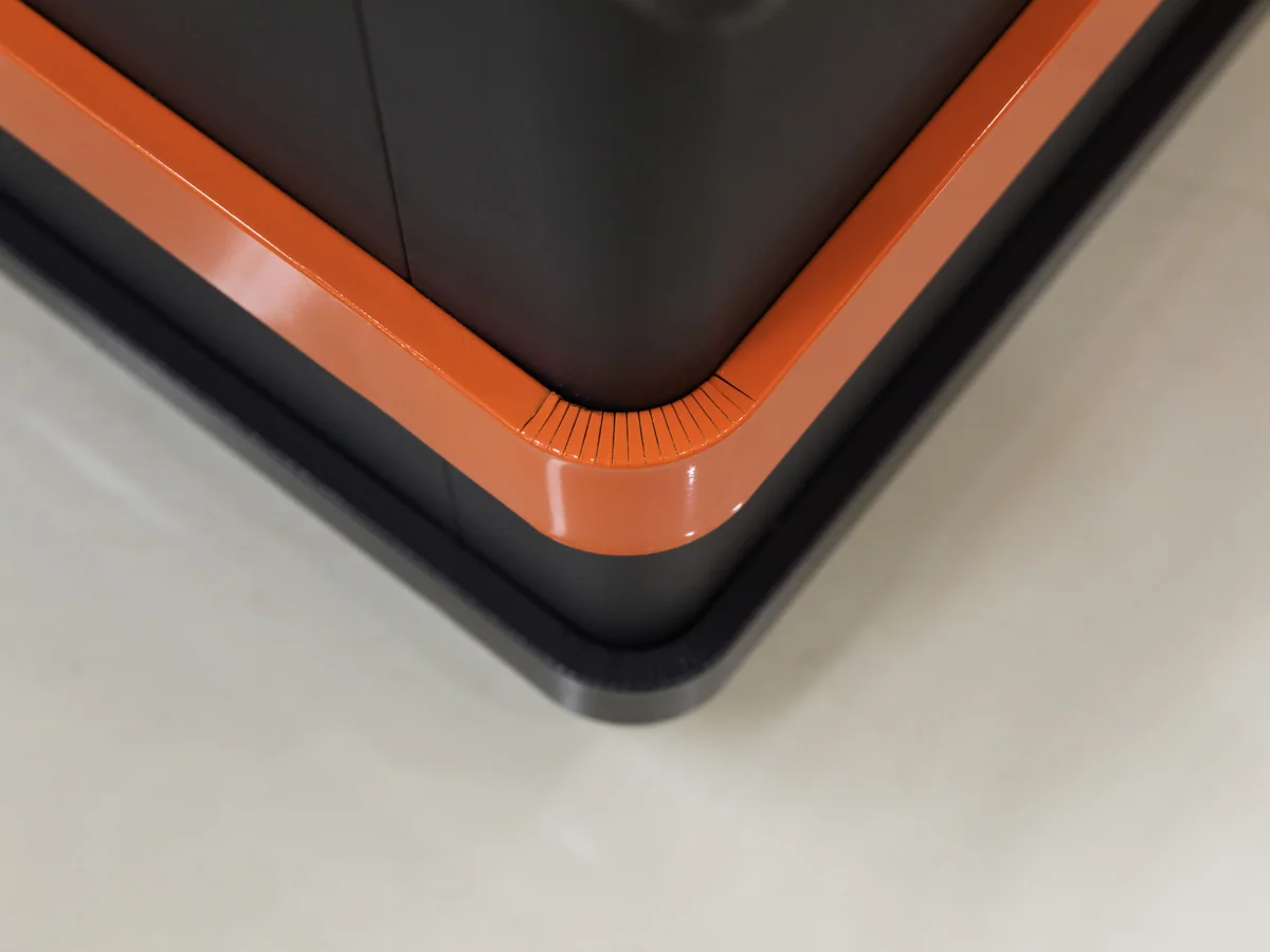 Close-up of the pressed stainless worktop and its edge above the banded panel