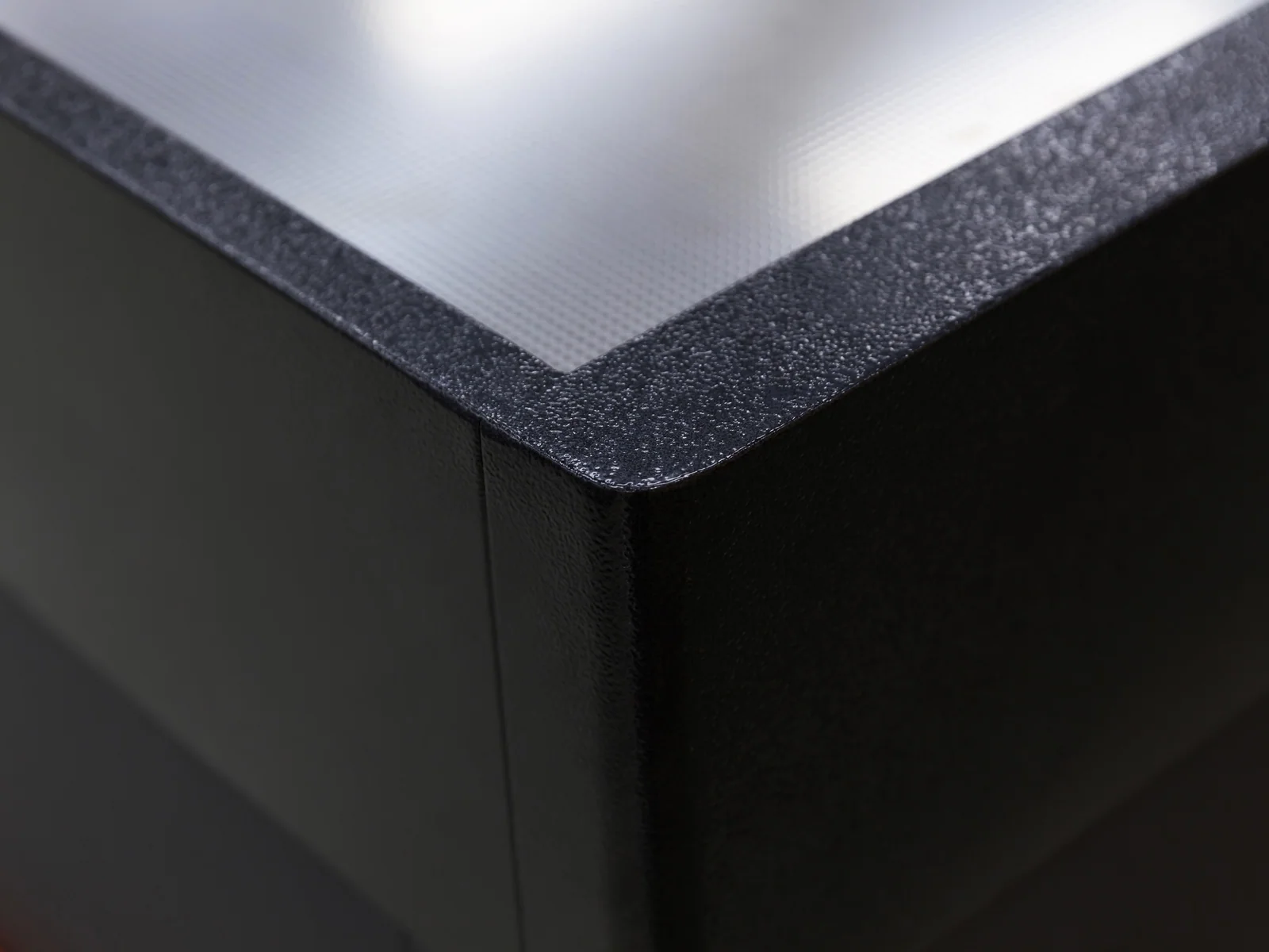 Banded front checkout counter photographed from the aisle, showing the accent band across the front