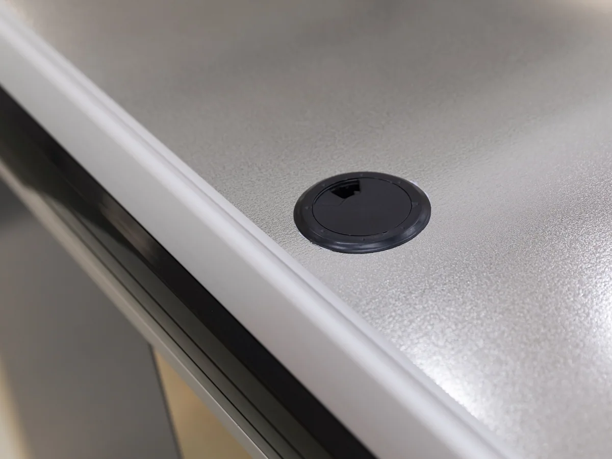 Dark kick plate along the base of a two-tone Keshun cashier counter