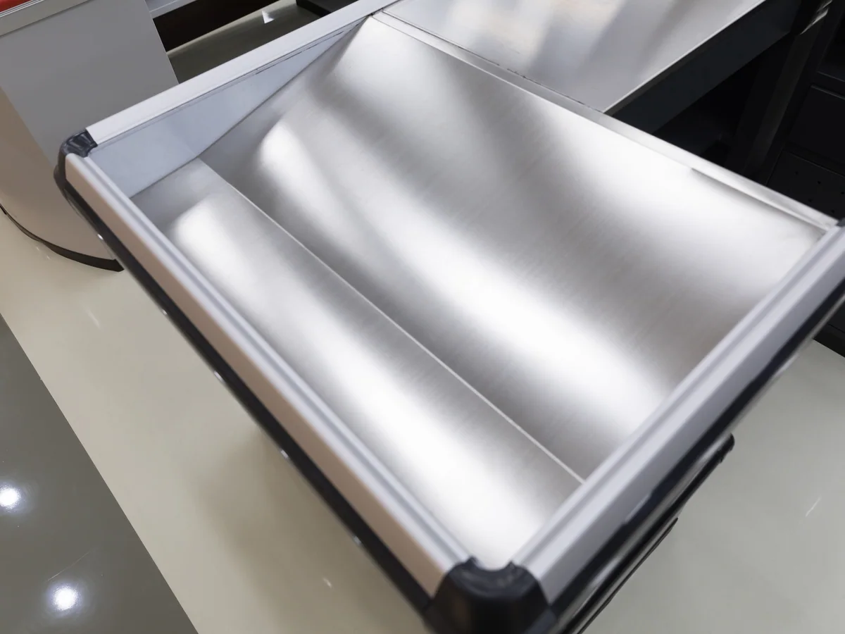 Close-up of the chrome bag holder rail mounted on the packing bay