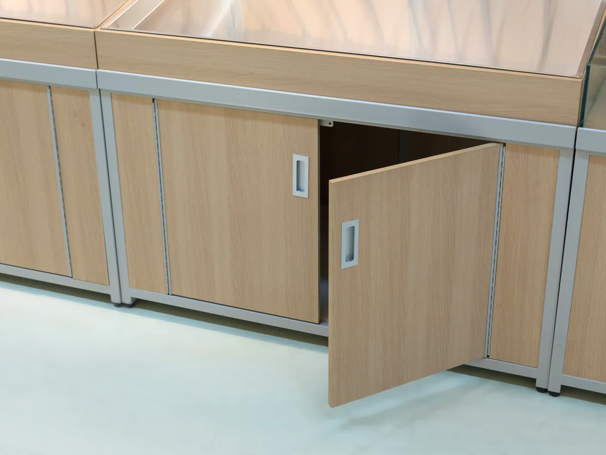 Close-up of the closed cabinet doors under the base table