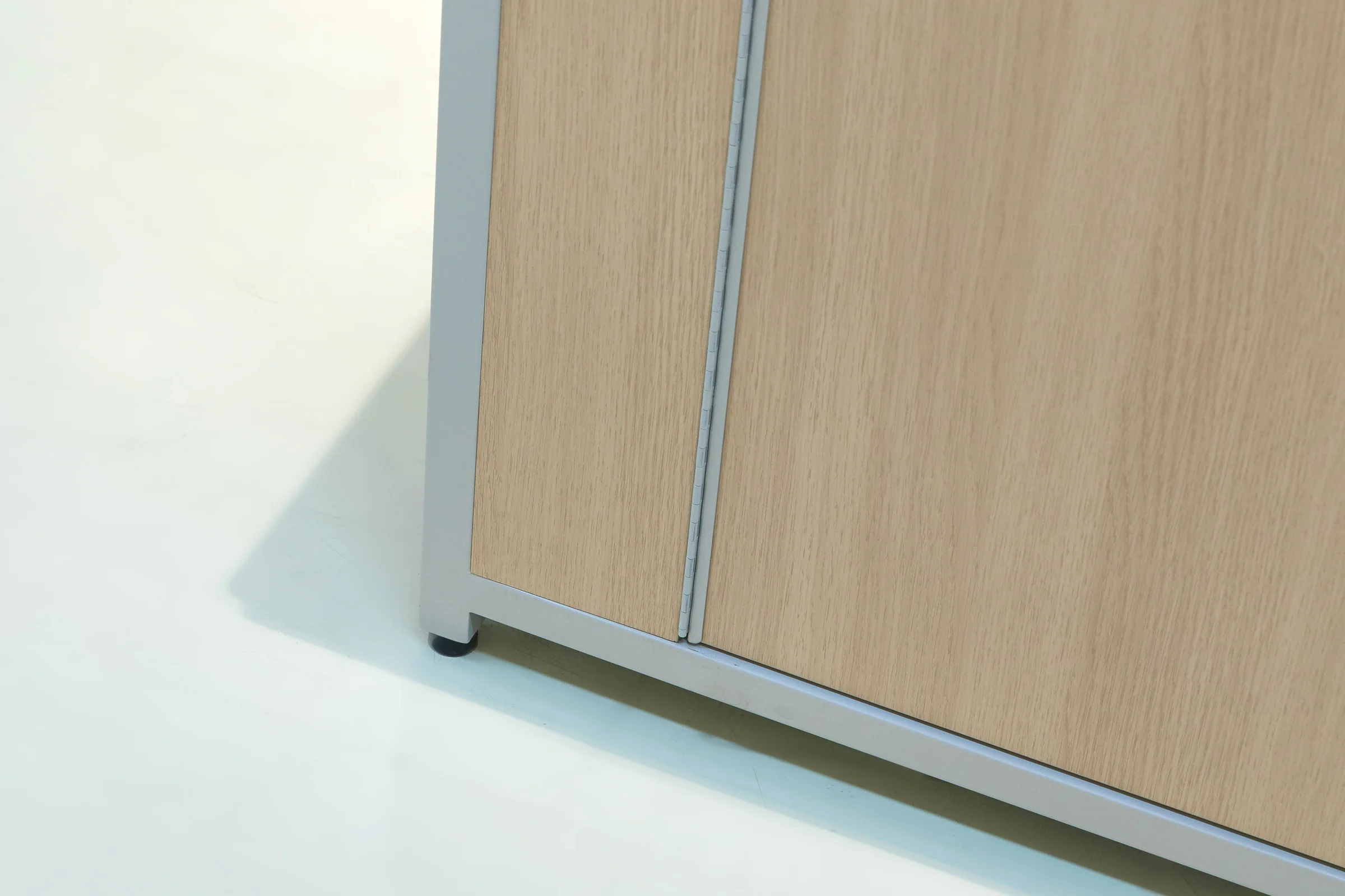 Keshun single-sided wall produce rack with angled shelf arms over a stainless base table