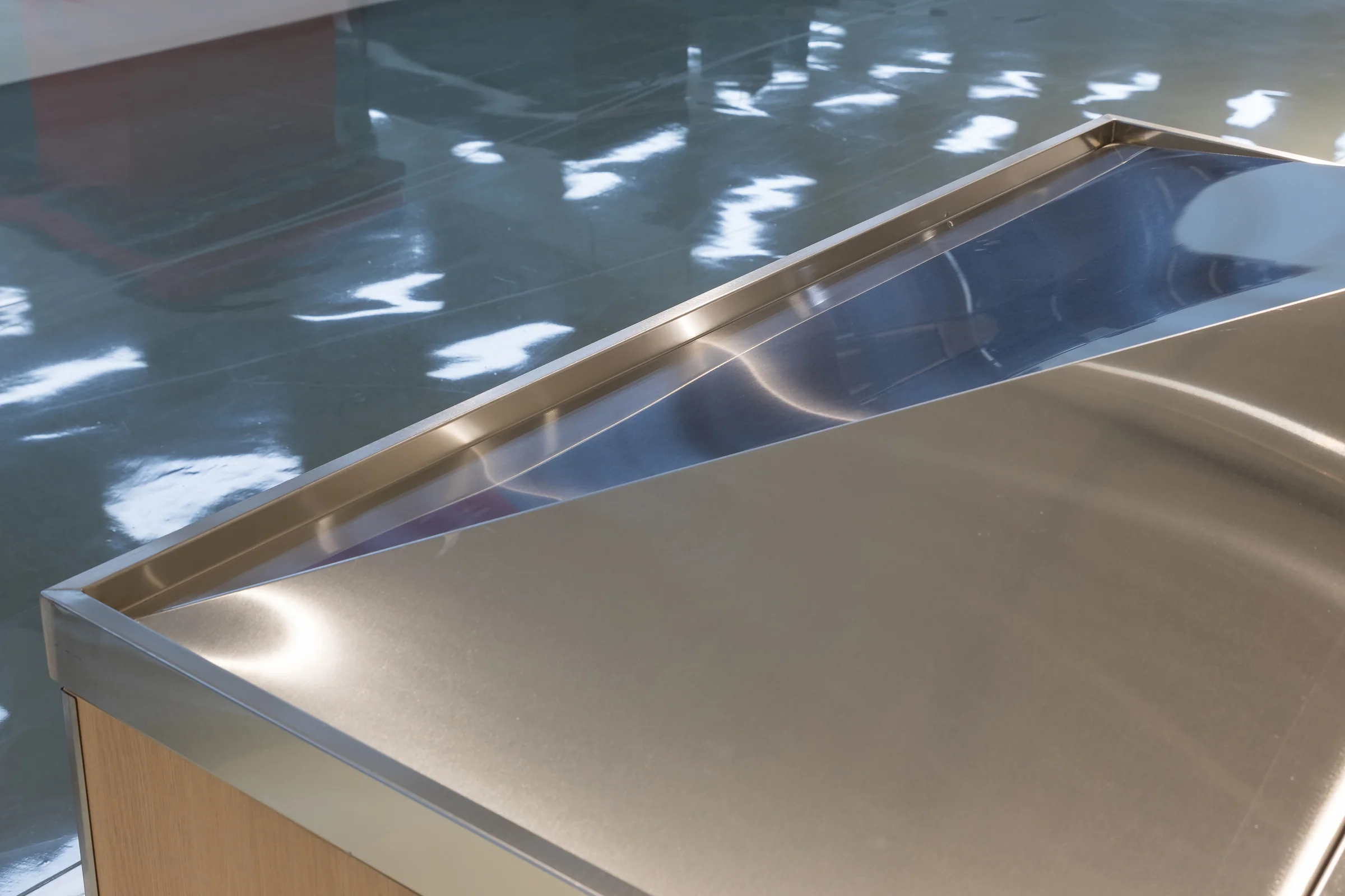 Keshun plain produce island with a pale slatted timber body under an unbroken stainless deck